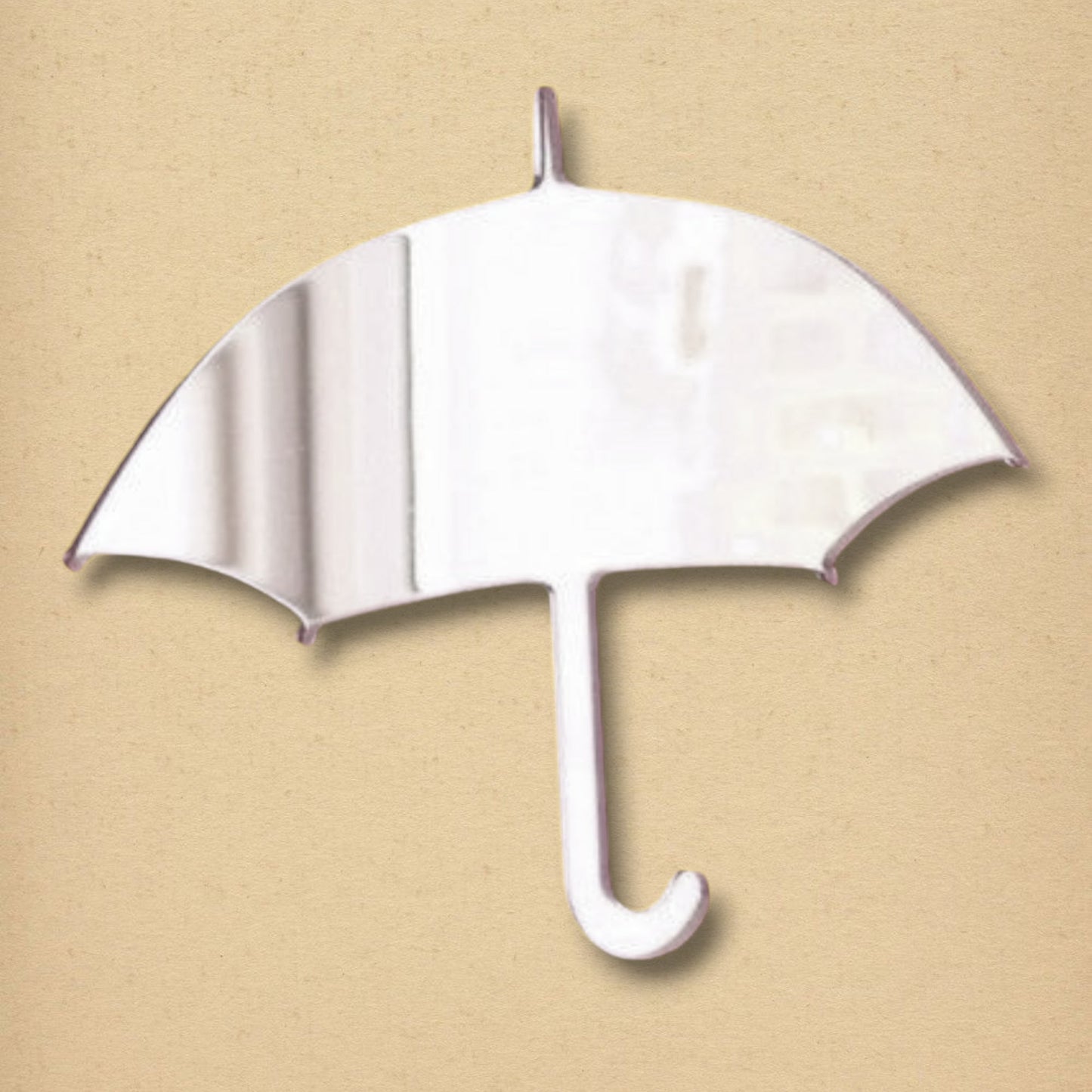 An umbrella-shaped mirror with a curved handle on a beige background.