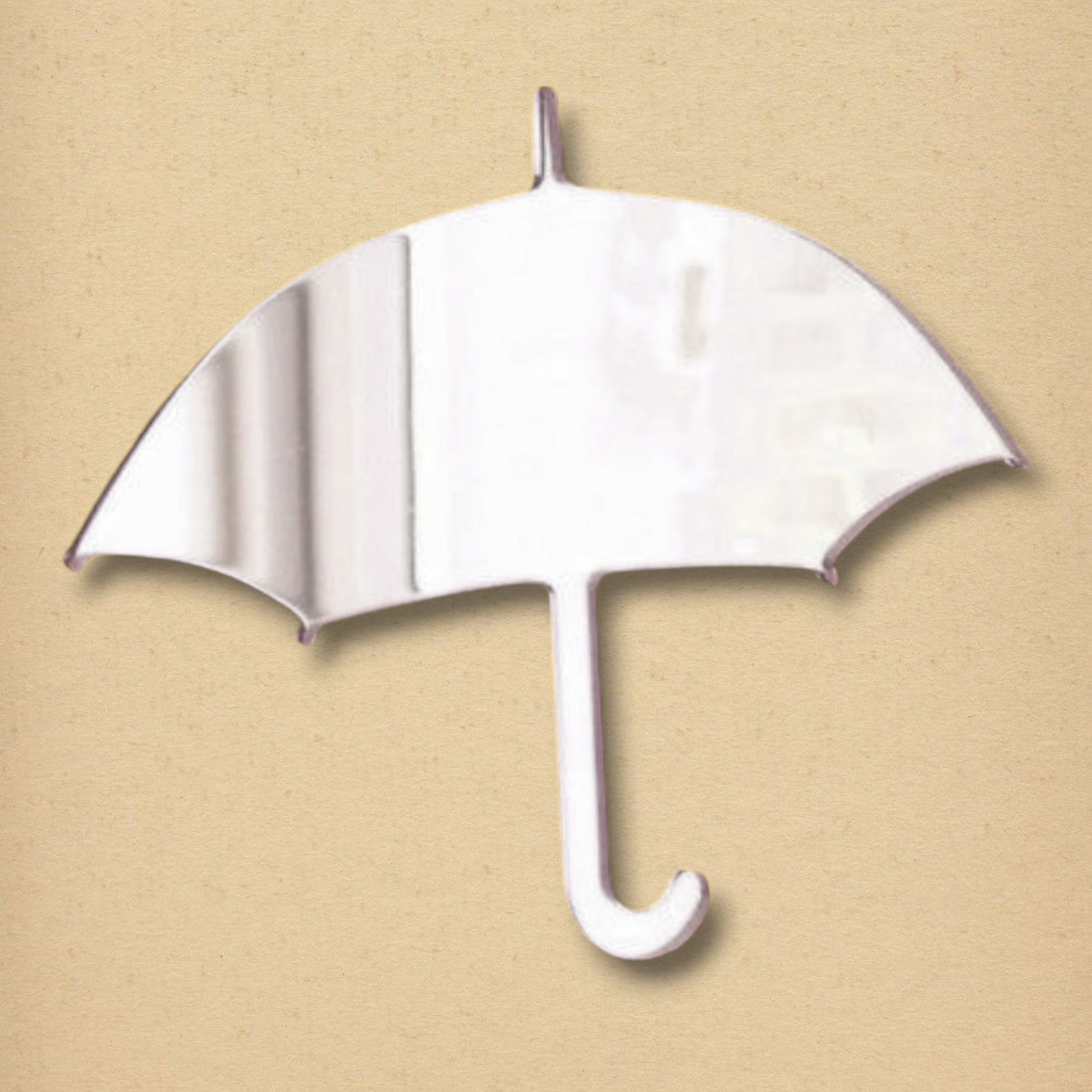 An umbrella-shaped mirror with a curved handle on a beige background.