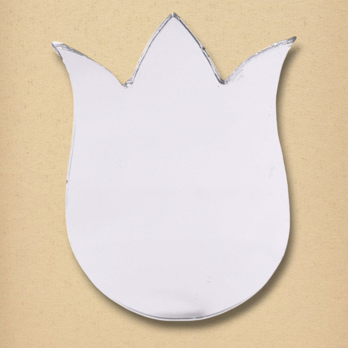 A tulip-shaped glass mirror on a neutral tan textured background.
