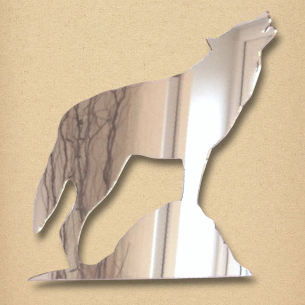 A silver mirror shaped like a howling wolf on a rock.