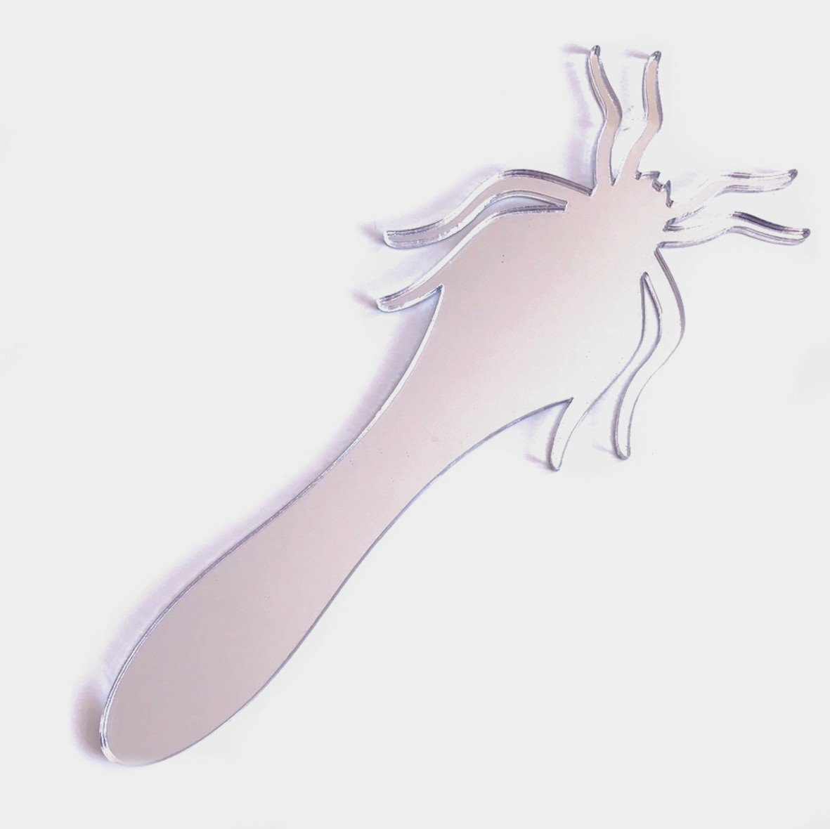 A silver, spider-shaped handheld mirror with stylized legs extending from the round mirror body and handle.