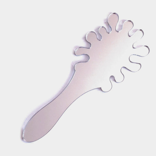 A splash-shaped silver hand-held mirror with a wavy, irregular edge and integrated handle on a white background.