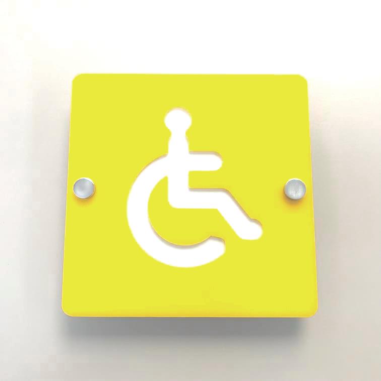 Square yellow disabled toilet sign with a white wheelchair symbol, mounted with two metal standoffs.