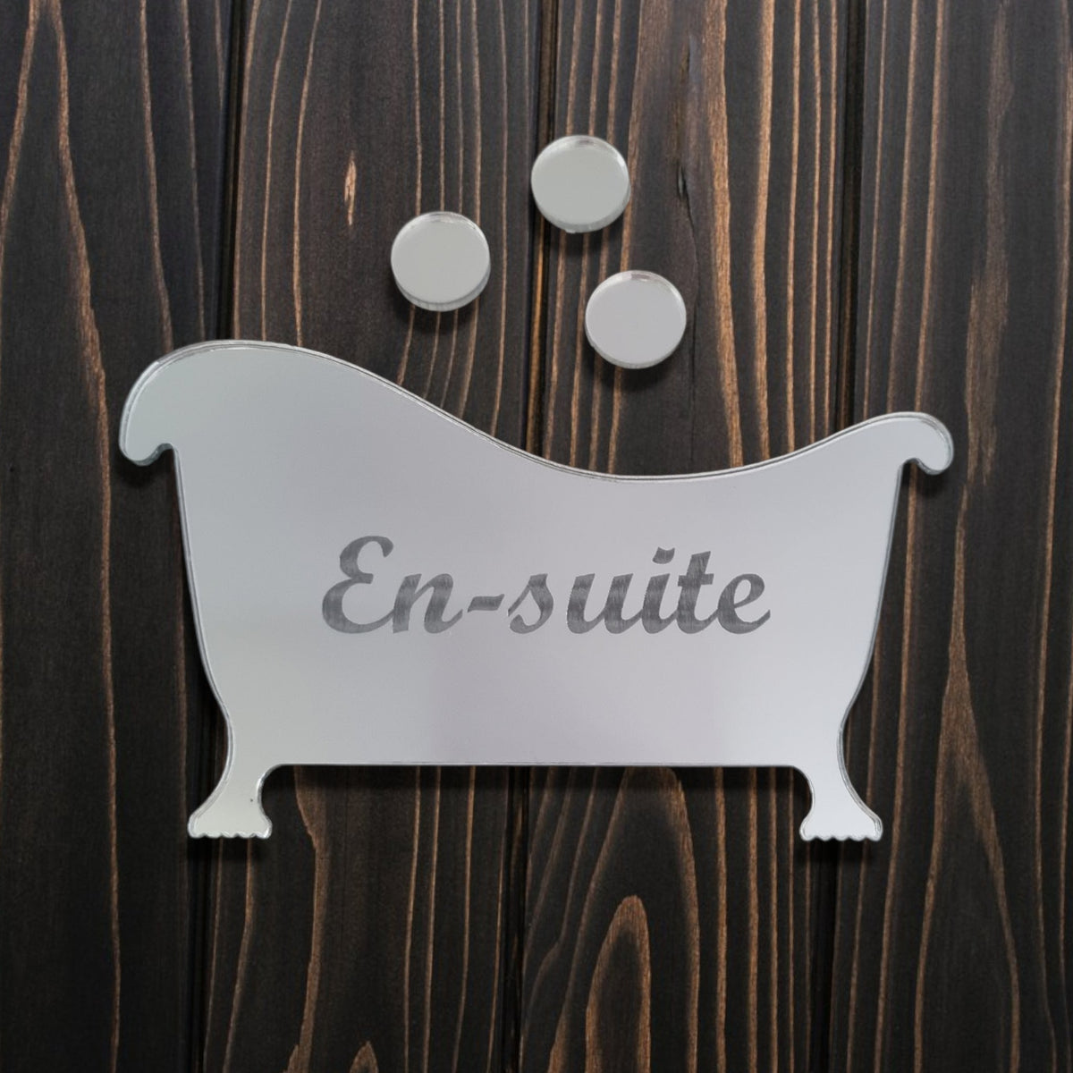 Bathtub-shaped mirrored acrylic sign with engraved "En-suite" text and three bubbles on wood.