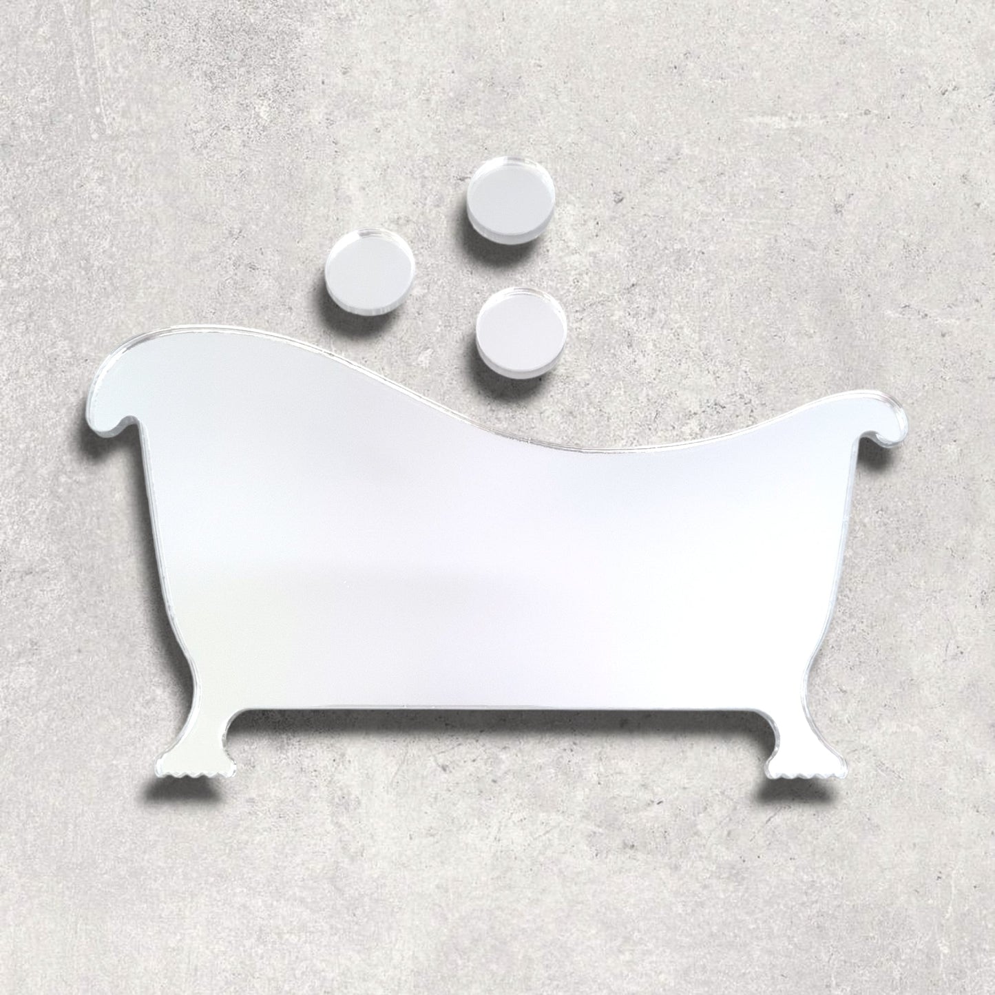 Mirrored bathtub sign with three round bubble-shaped mirrors above it on a grey surface.