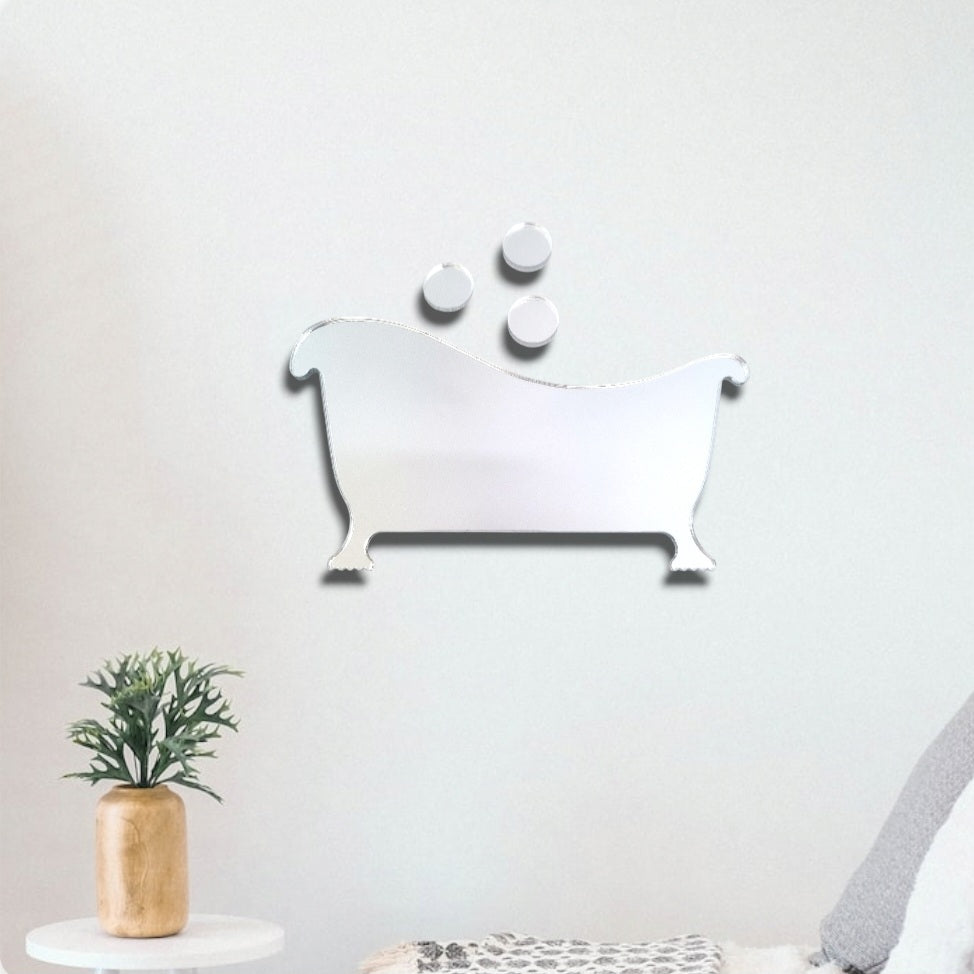 Bathtub and bubble-shaped mirrored wall art mounted on a white wall.