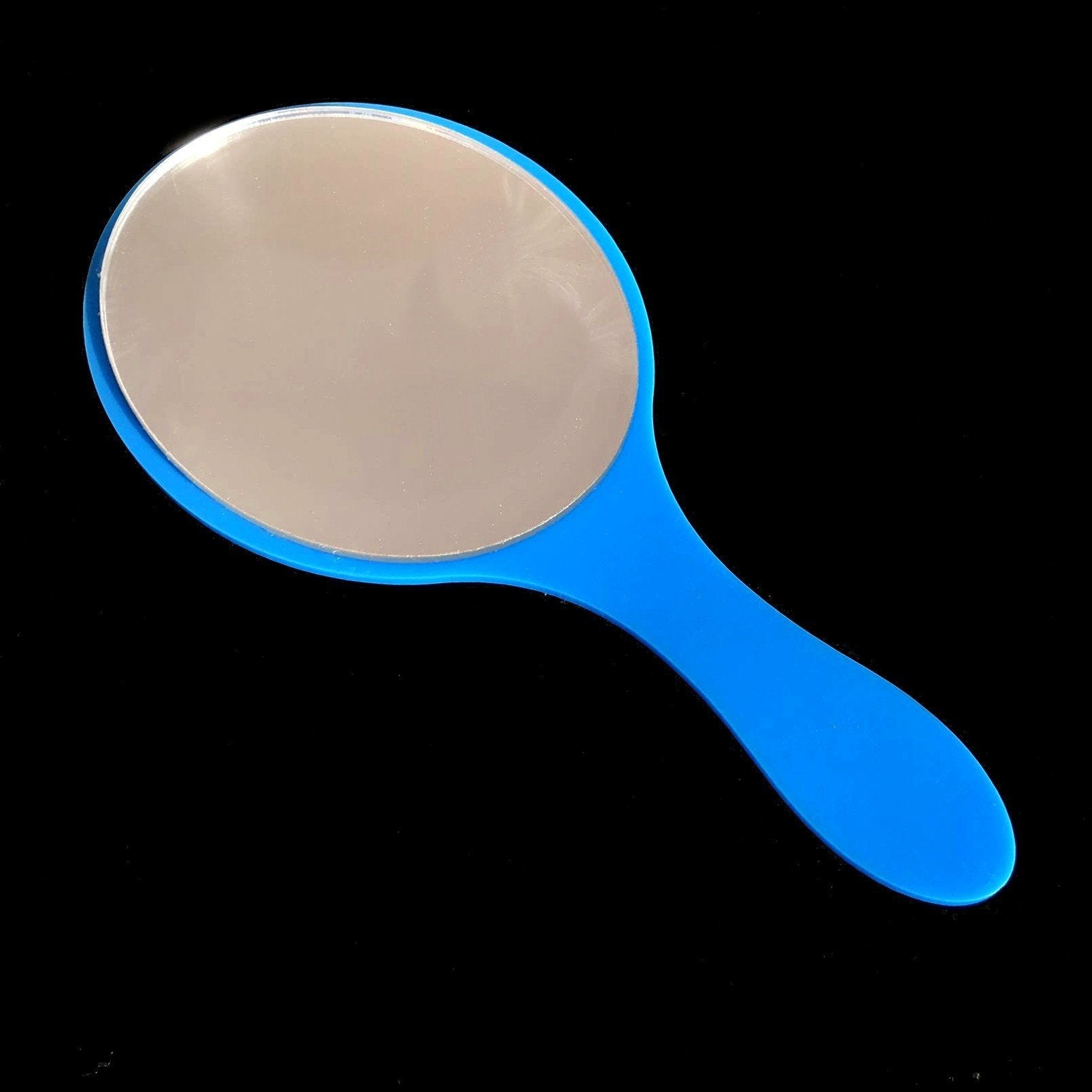 An oval hand-held mirror with a bright blue gloss plastic frame and handle against a black background.