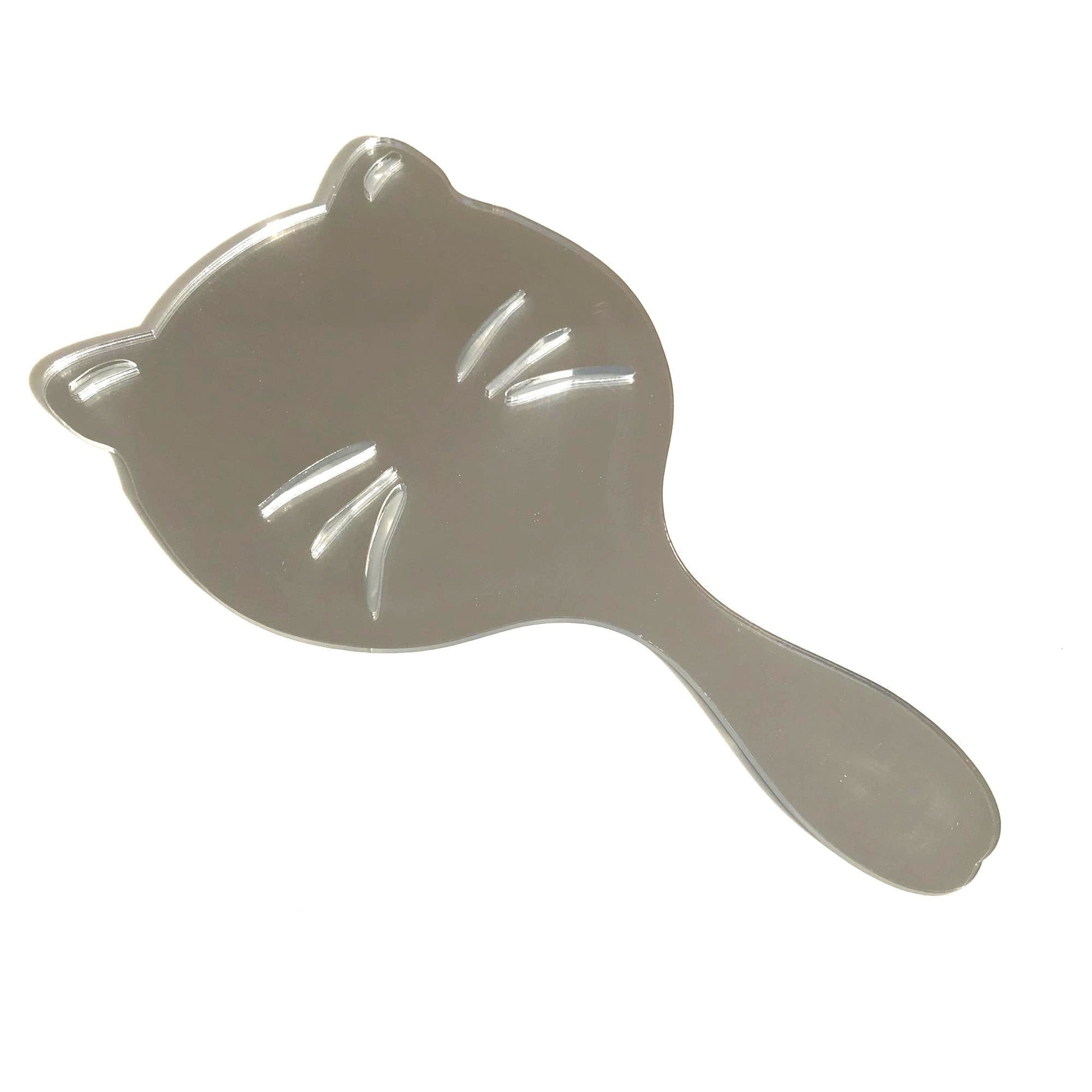 Silver cat-shaped hand-held mirror with engraved whiskers and an attached handle on a white background.