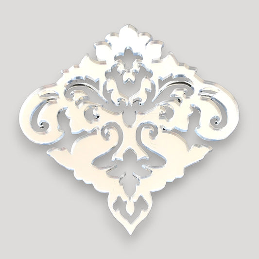 Decorative silver damask mirror with intricate floral and scrollwork cutout patterns.