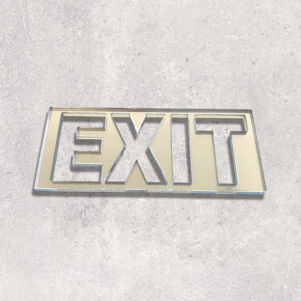 A rectangular reflective mirror with the word EXIT cut out in block letters.