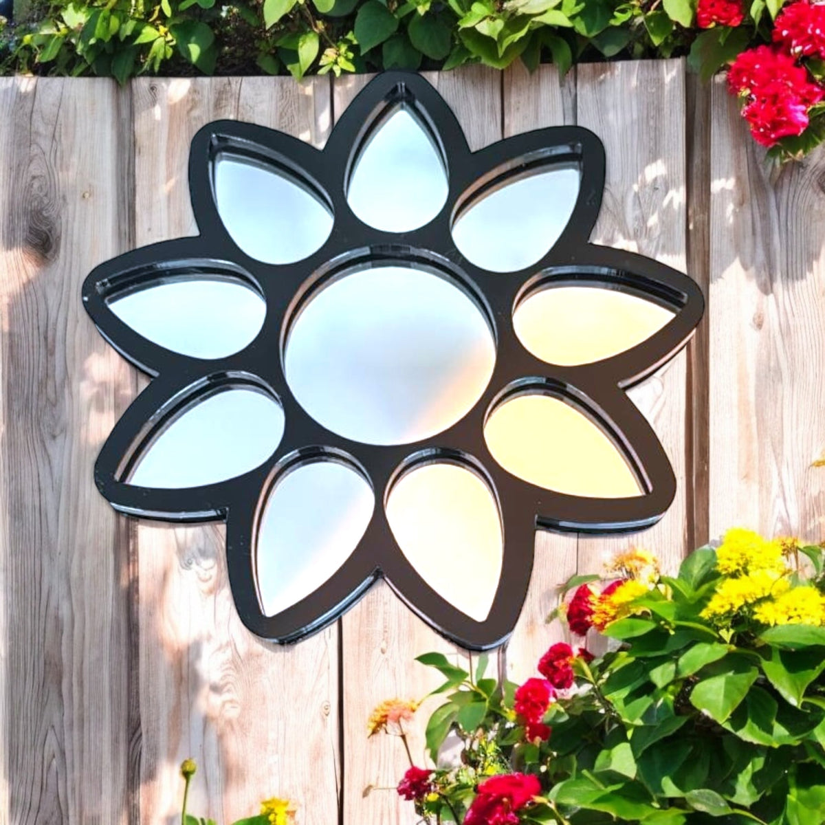 Flower Garden Mirror with a black frame and multiple petal-shaped mirror panels surrounding a round center mirror.