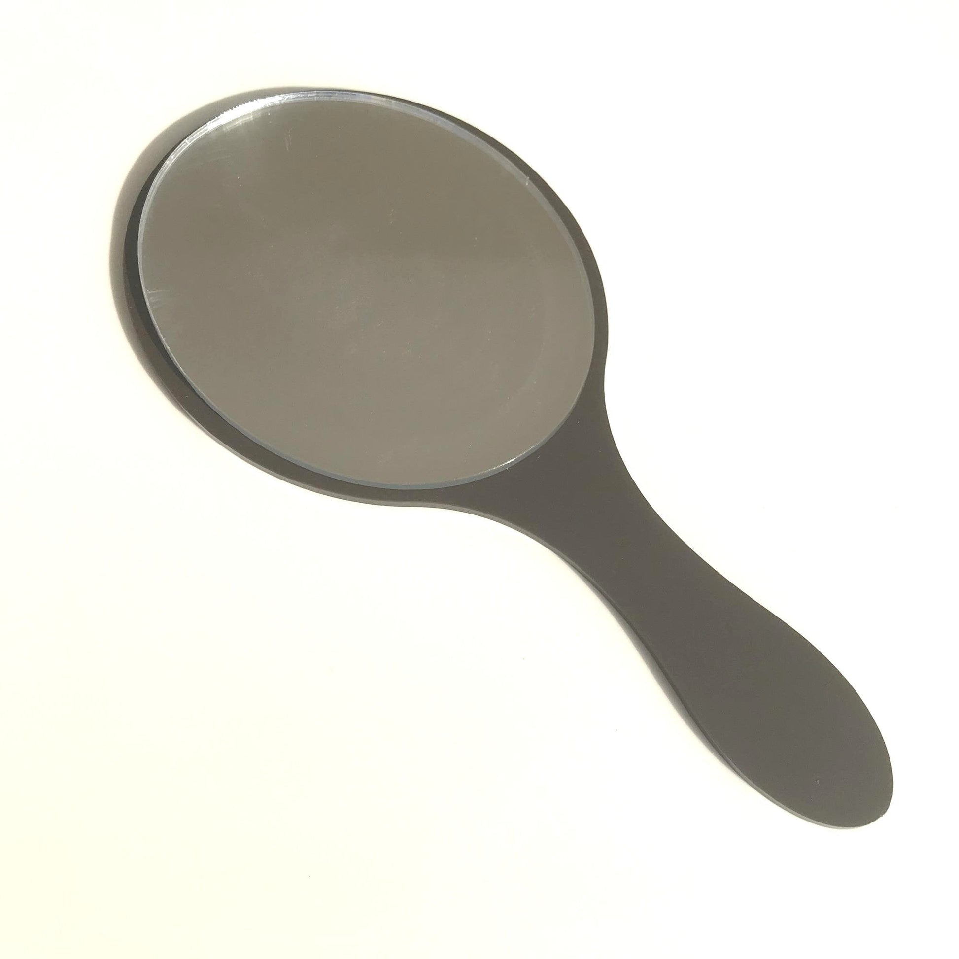 An oval hand-held mirror with a solid black handle on a white background.