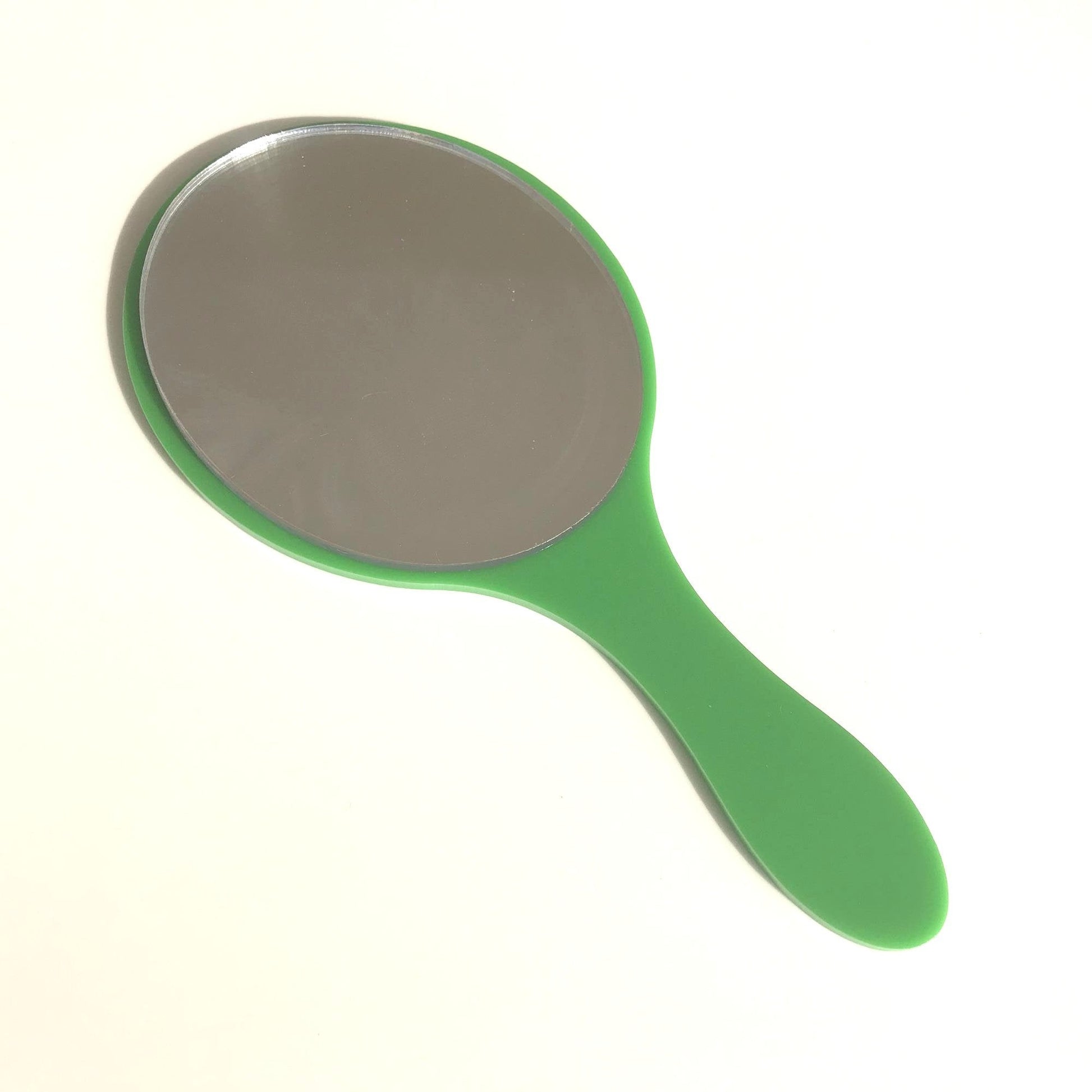 Oval hand-held mirror with a glossy green plastic handle on a white background.