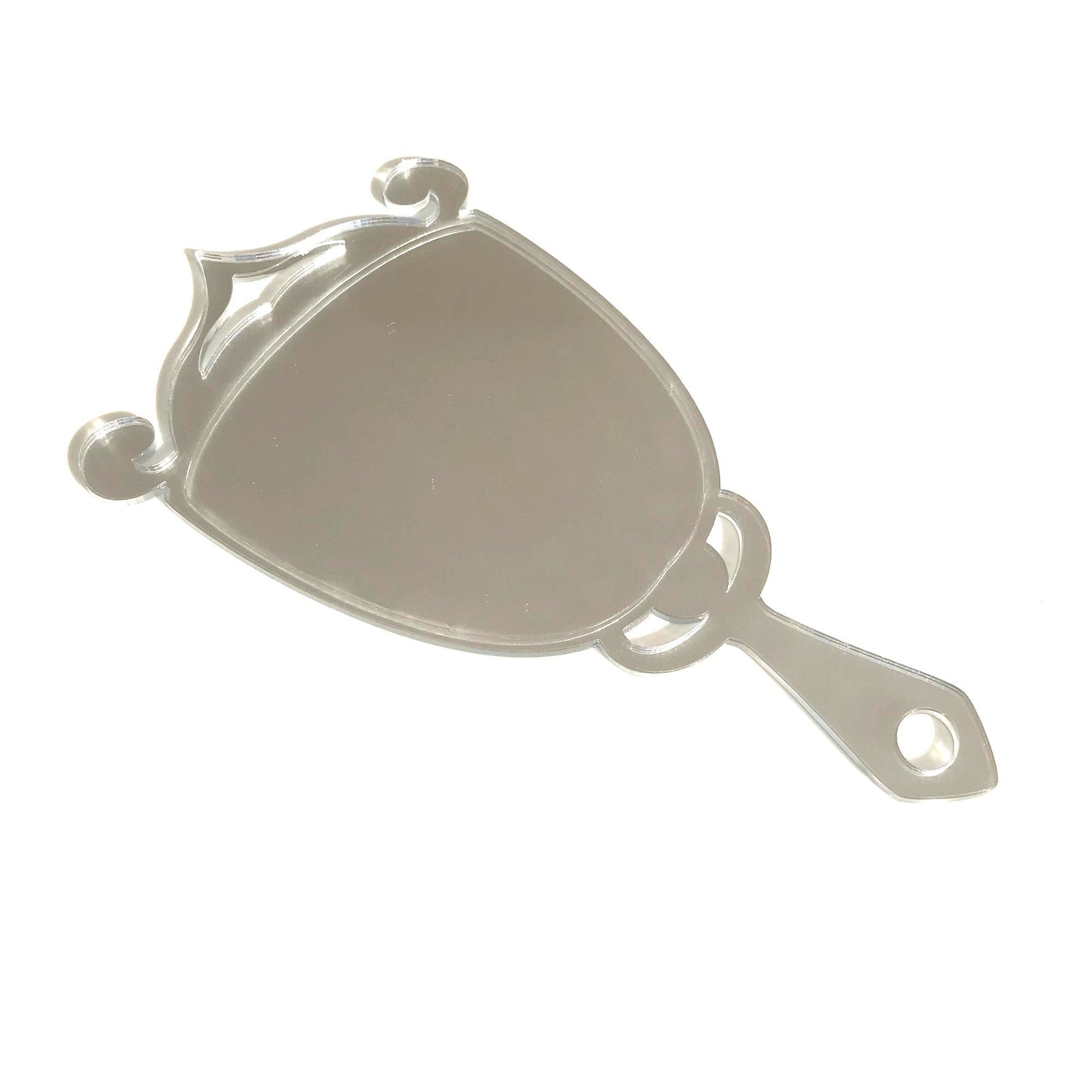 Art Deco trophy hand-held mirror with a reflective silver finish, ornate scroll top, and a pierced handle.