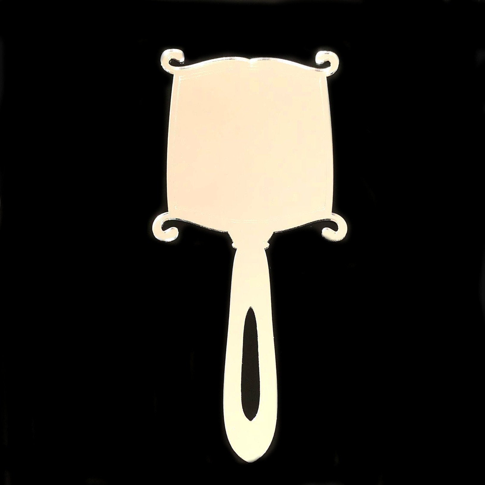 Art Deco rectangular hand-held mirror with curved corners, scroll accents, and a handle with a cutout.