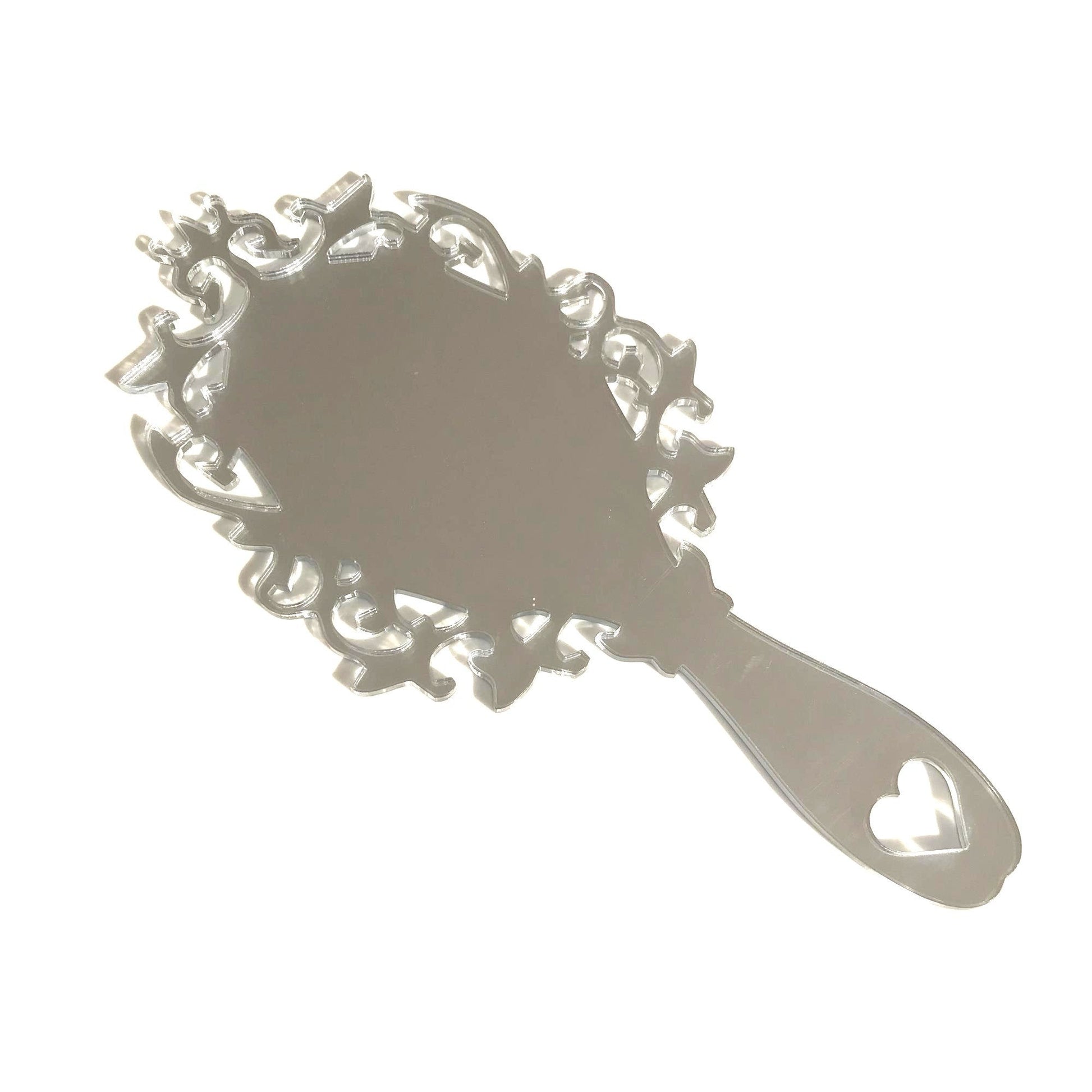 Victorian vintage-style hand-held mirror with an ornate, filigree frame and a heart cutout on the handle.