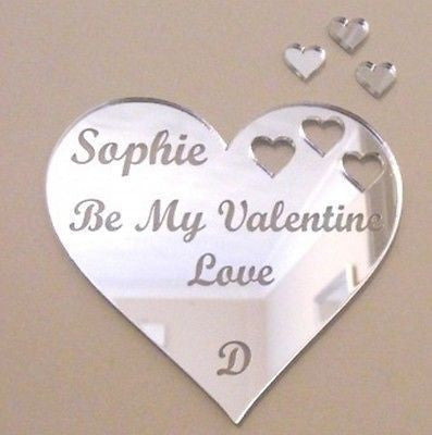 Engraved silver acrylic heart mirror with three heart cutout pieces and matching mini hearts.