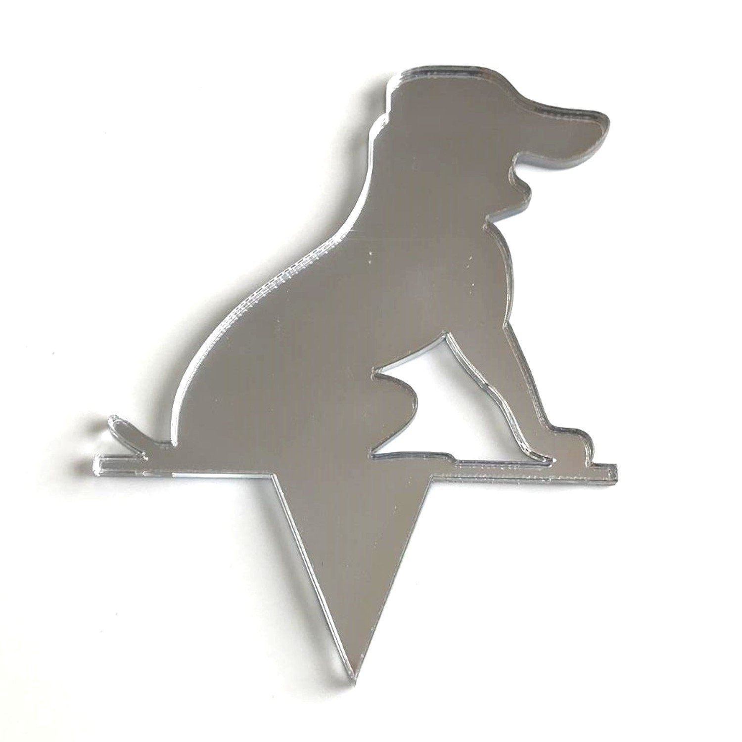 Silver-mirrored acrylic cake topper in the silhouette shape of a sitting Beagle dog with a pointed base.