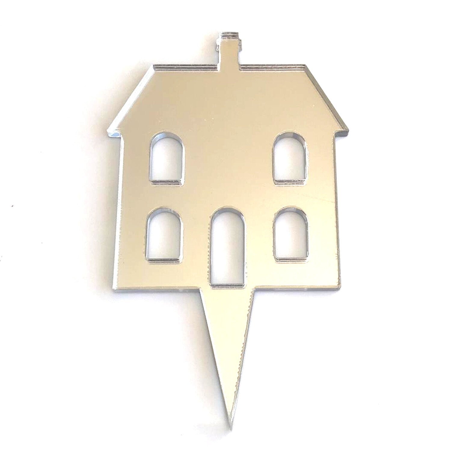 Silver mirrored acrylic cake topper shaped like a house with cut-out windows and a pointed base for insertion.
