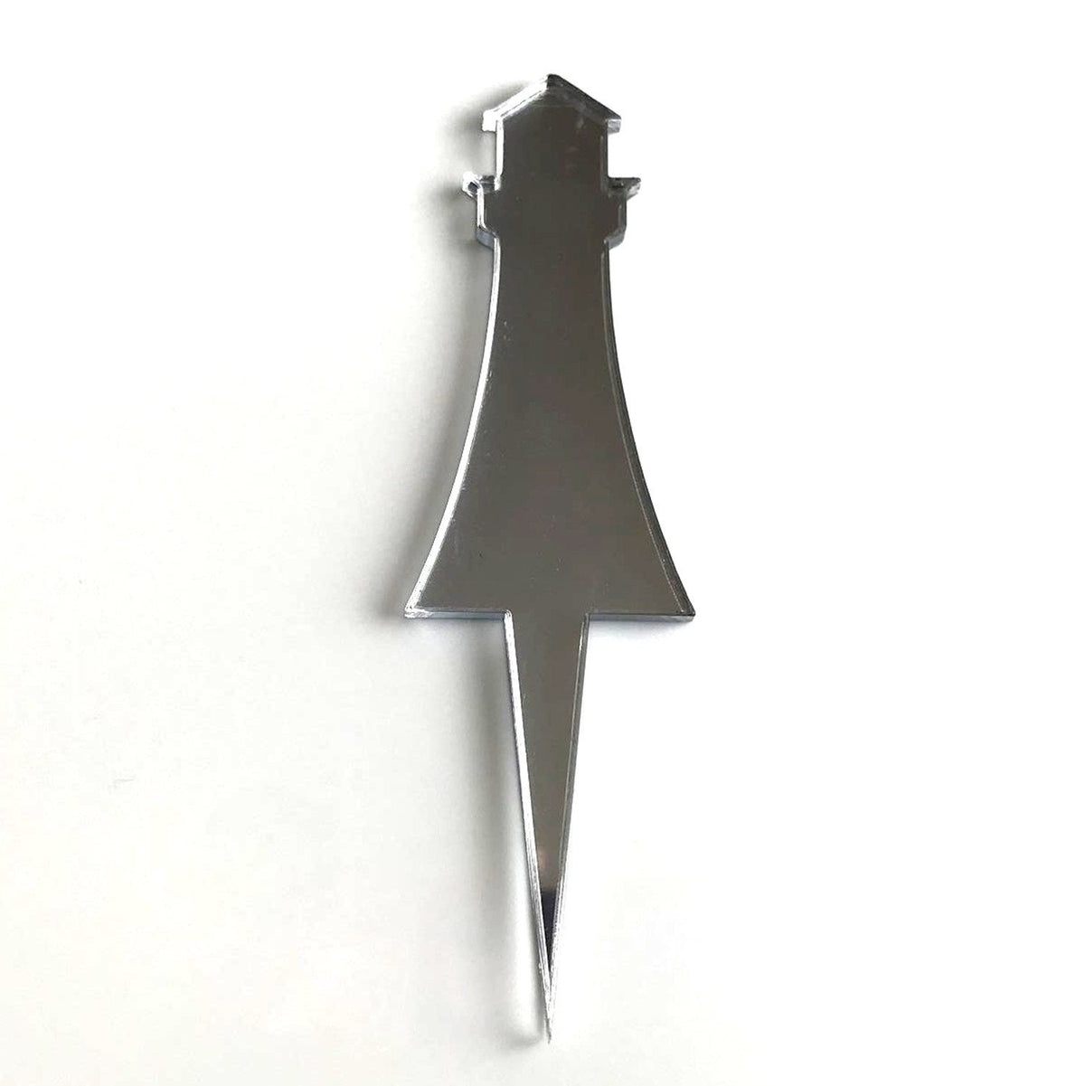 Mirror-finish silver lighthouse cake topper with a sharp, pointed stake base on a plain white background.