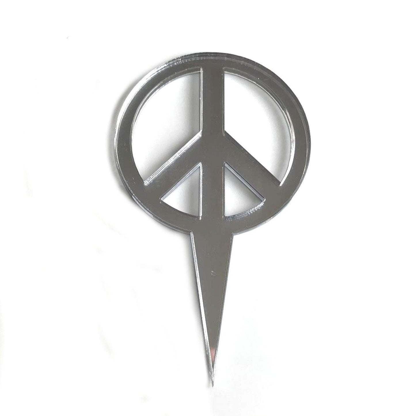 Reflective silver peace sign cake topper made of recycled acrylic, shown against a plain white background.