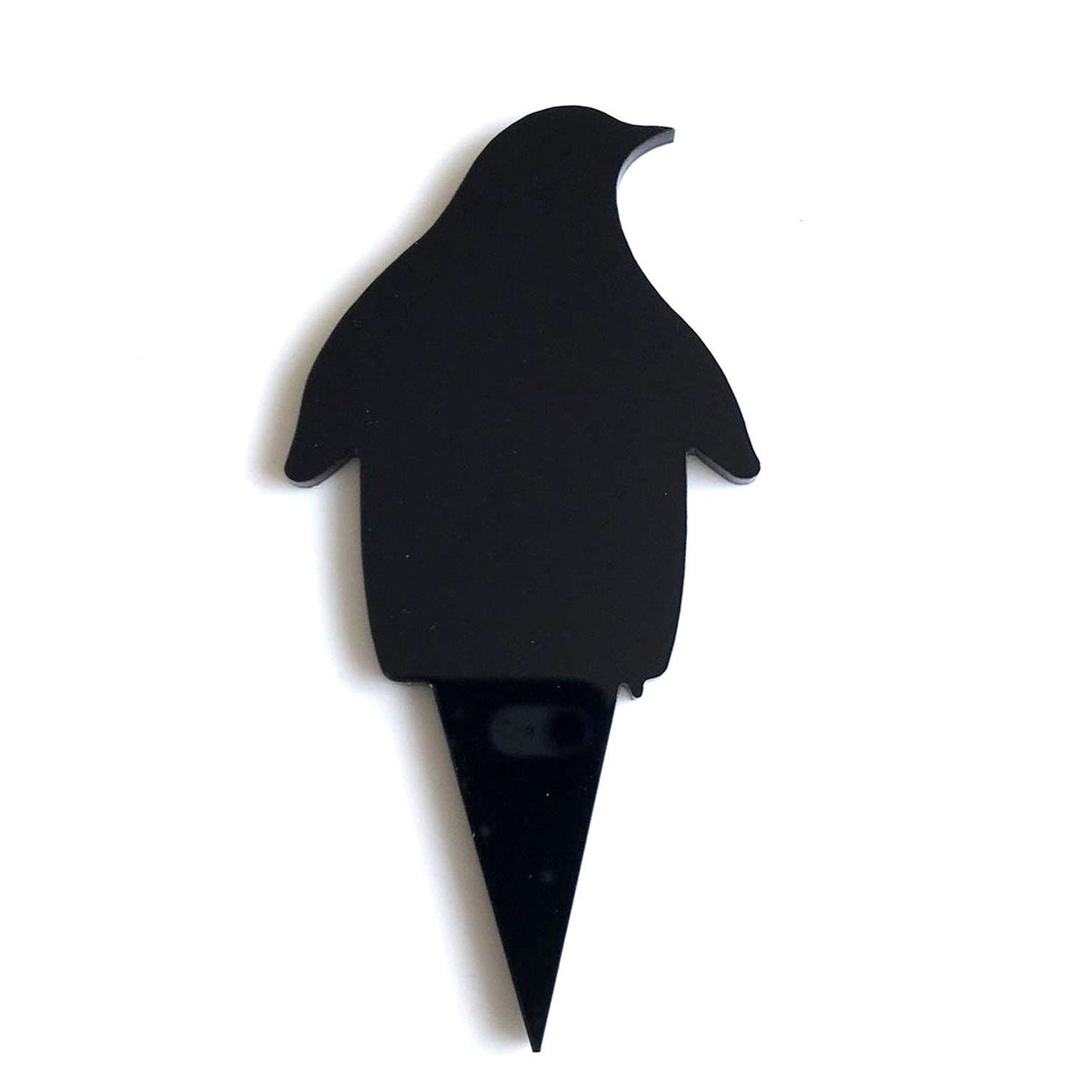 Black, penguin-shaped cake topper with a sharp stake, made of smooth, glossy eco-friendly material.