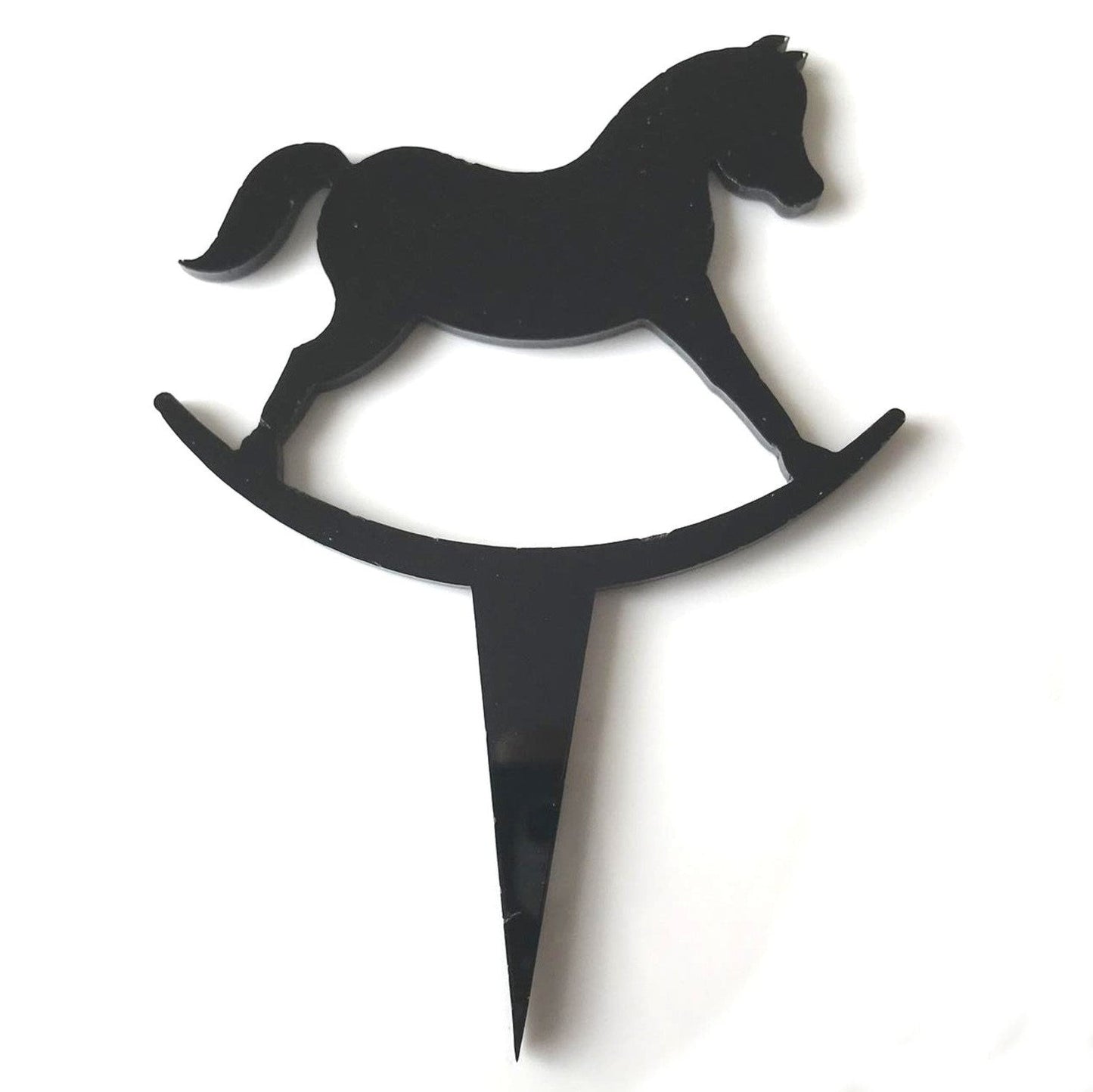 Glossy black acrylic rocking horse cake topper with a sharp pointed base for inserting into a cake.