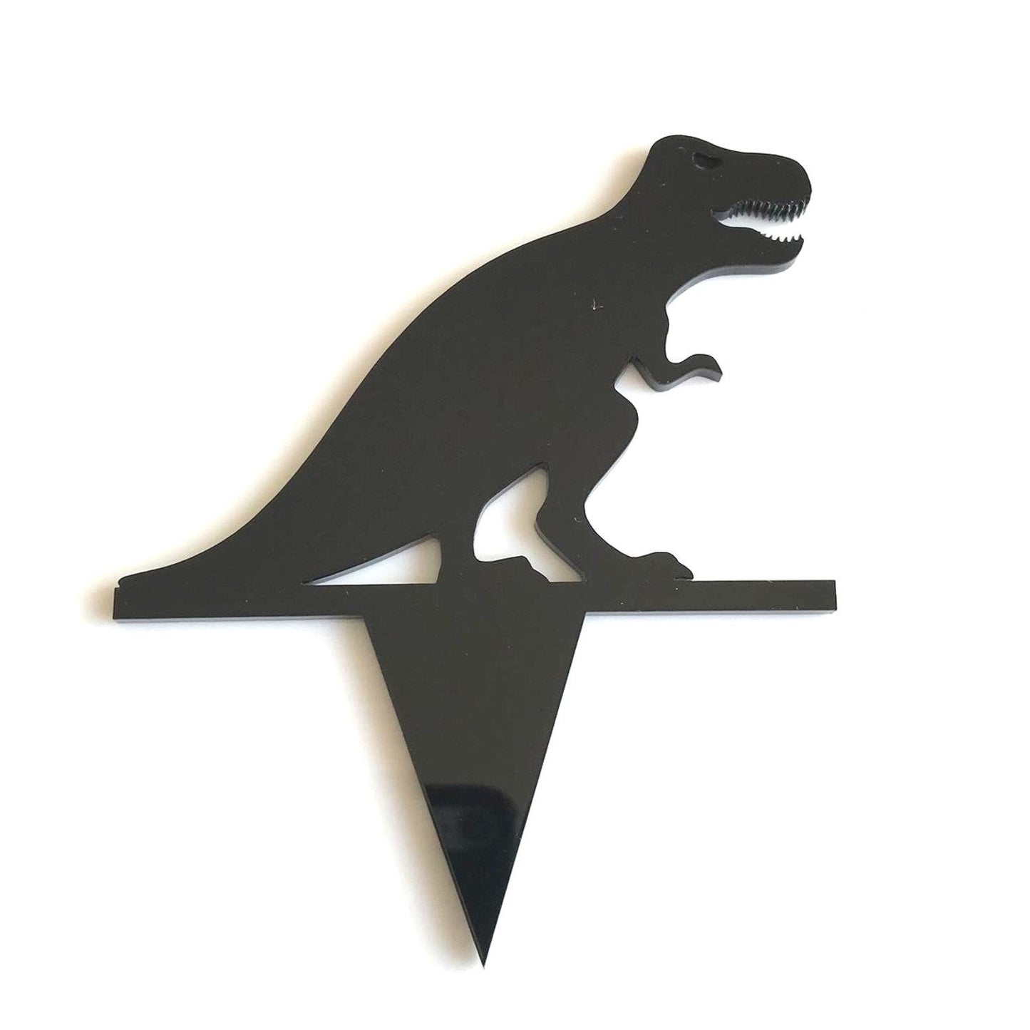 Black acrylic T-Rex silhouette cake topper with a sharp pointed base for inserting into food.