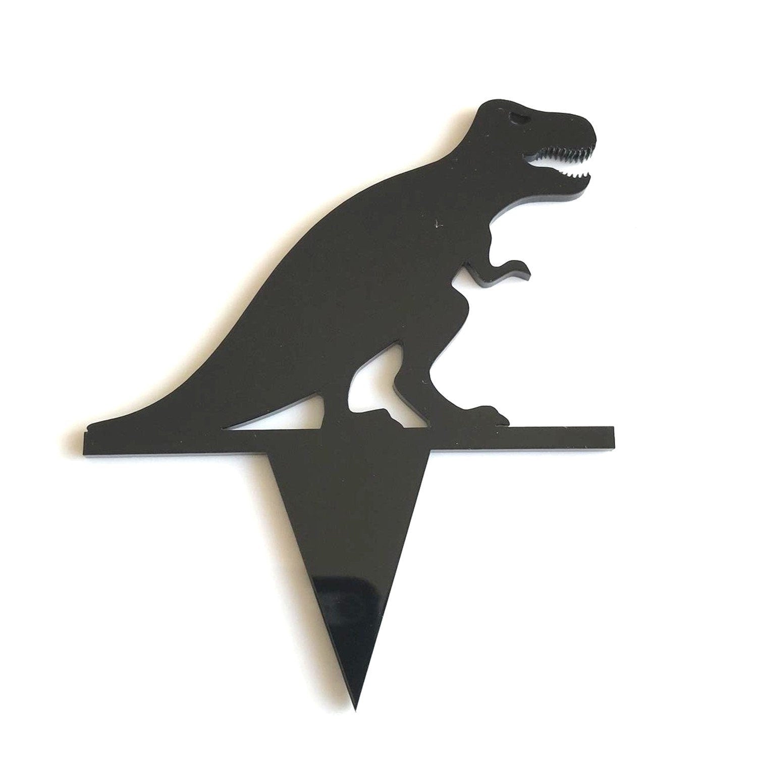 Black acrylic T-Rex silhouette cake topper with a sharp pointed base for inserting into food.
