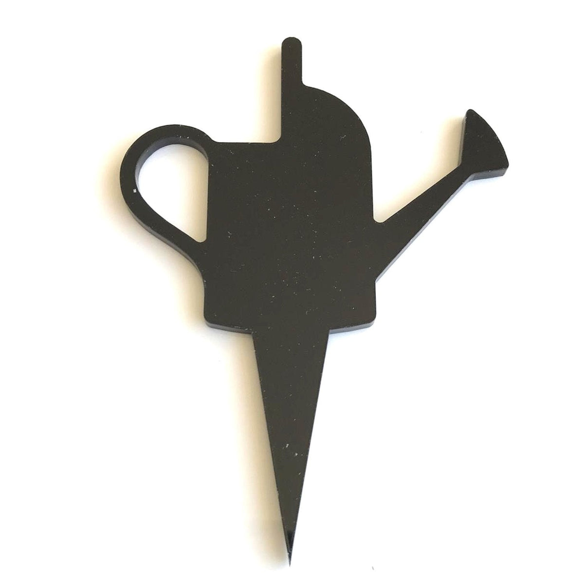Black acrylic watering can cake topper with a sharp, pointed base, isolated against a white background.
