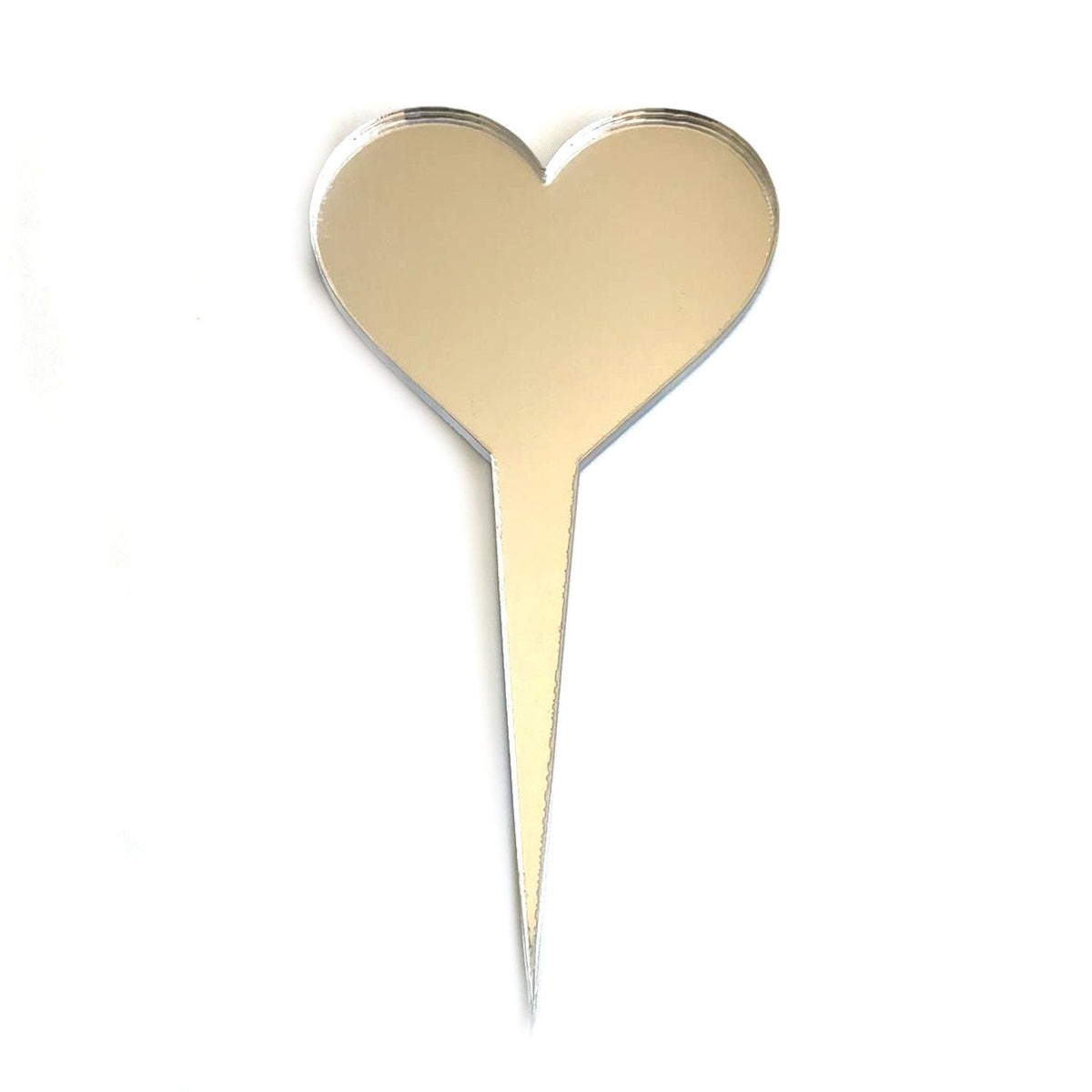 A reflective, mirror-finish heart-shaped cake topper with a sharp pointed spike, isolated on a white background.