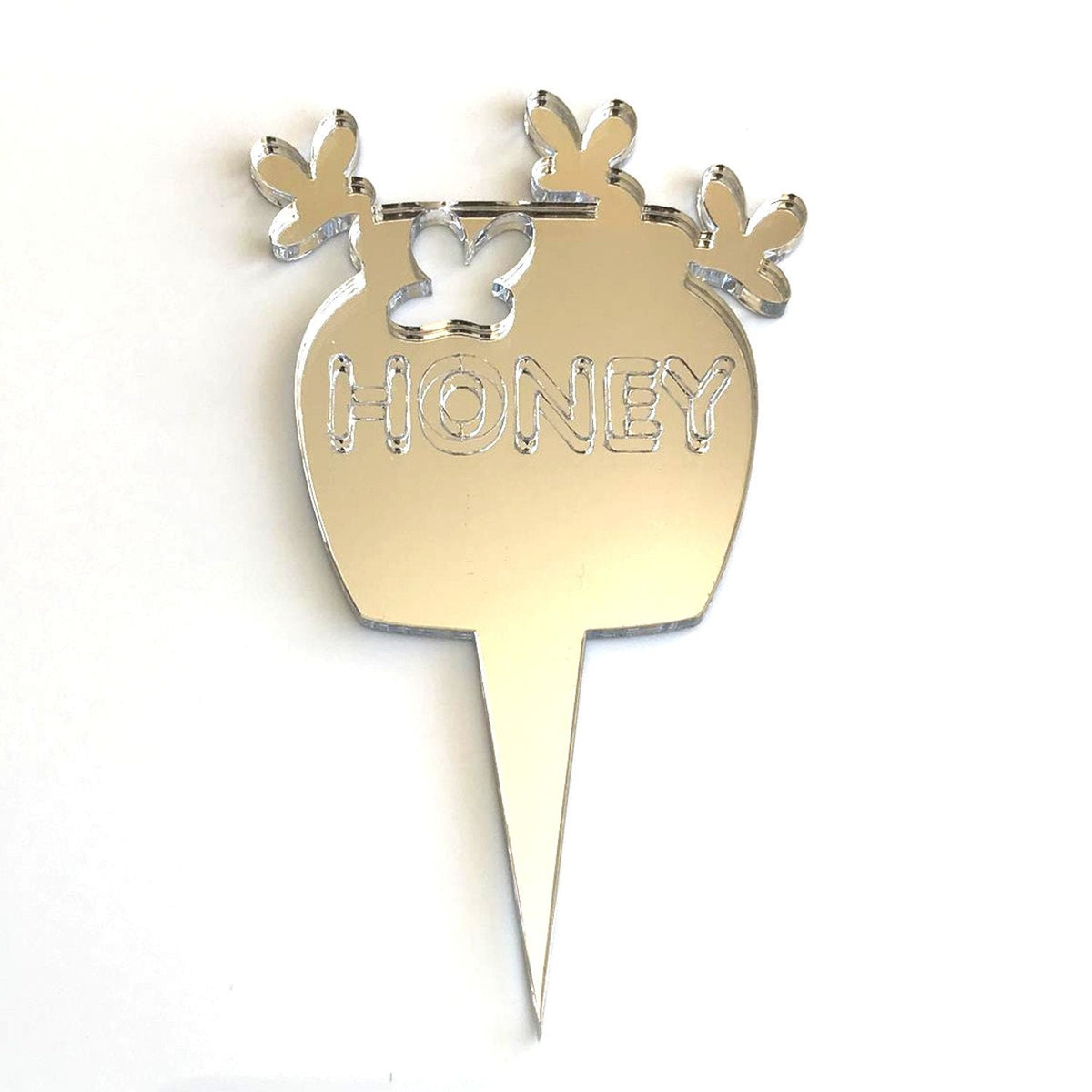 Silver mirror acrylic cake topper shaped like a honeypot with a butterfly cutout and the word "HONEY" engraved.