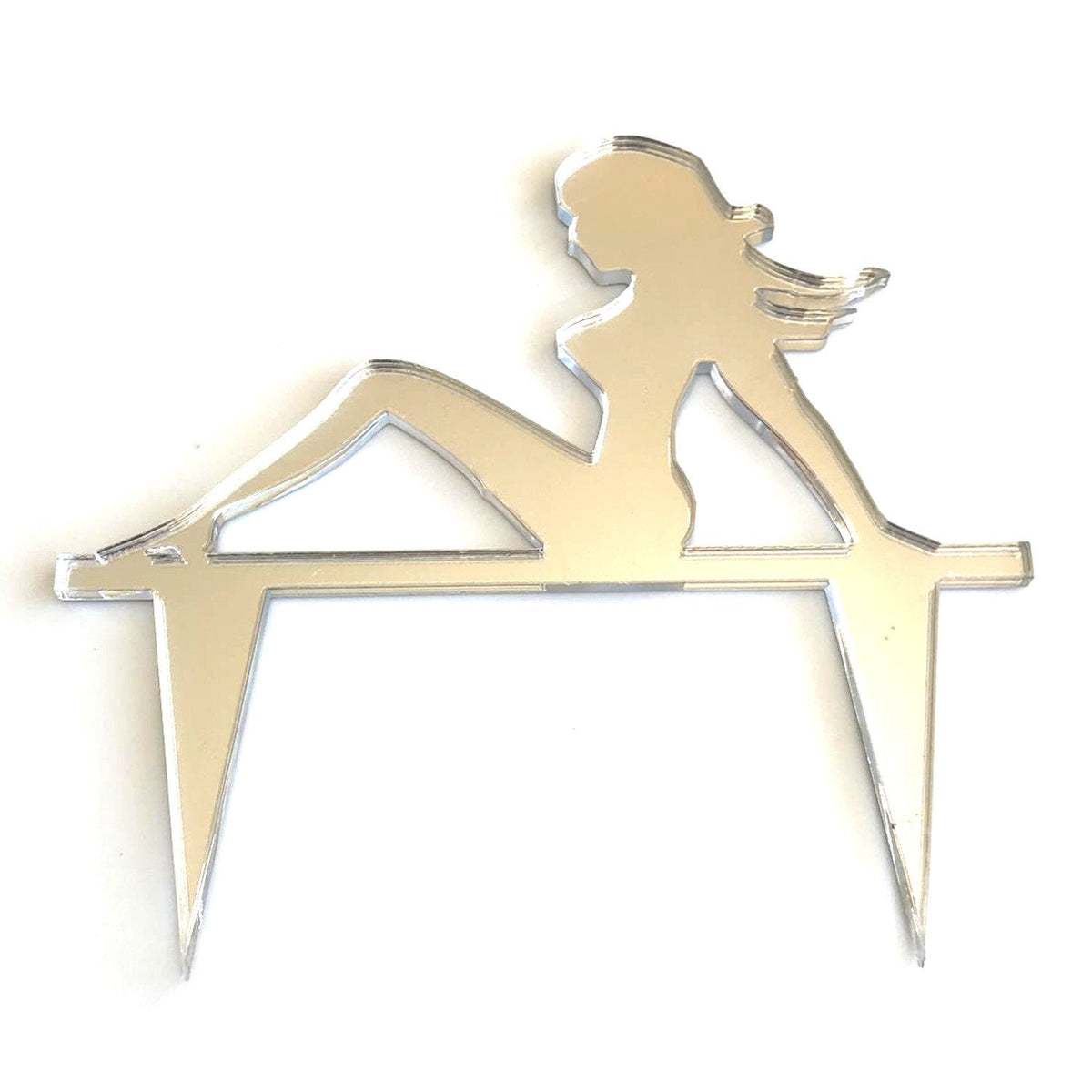 Silver mirror-finish acrylic cake topper shaped like a reclining silhouette of a trucker mascot lady.