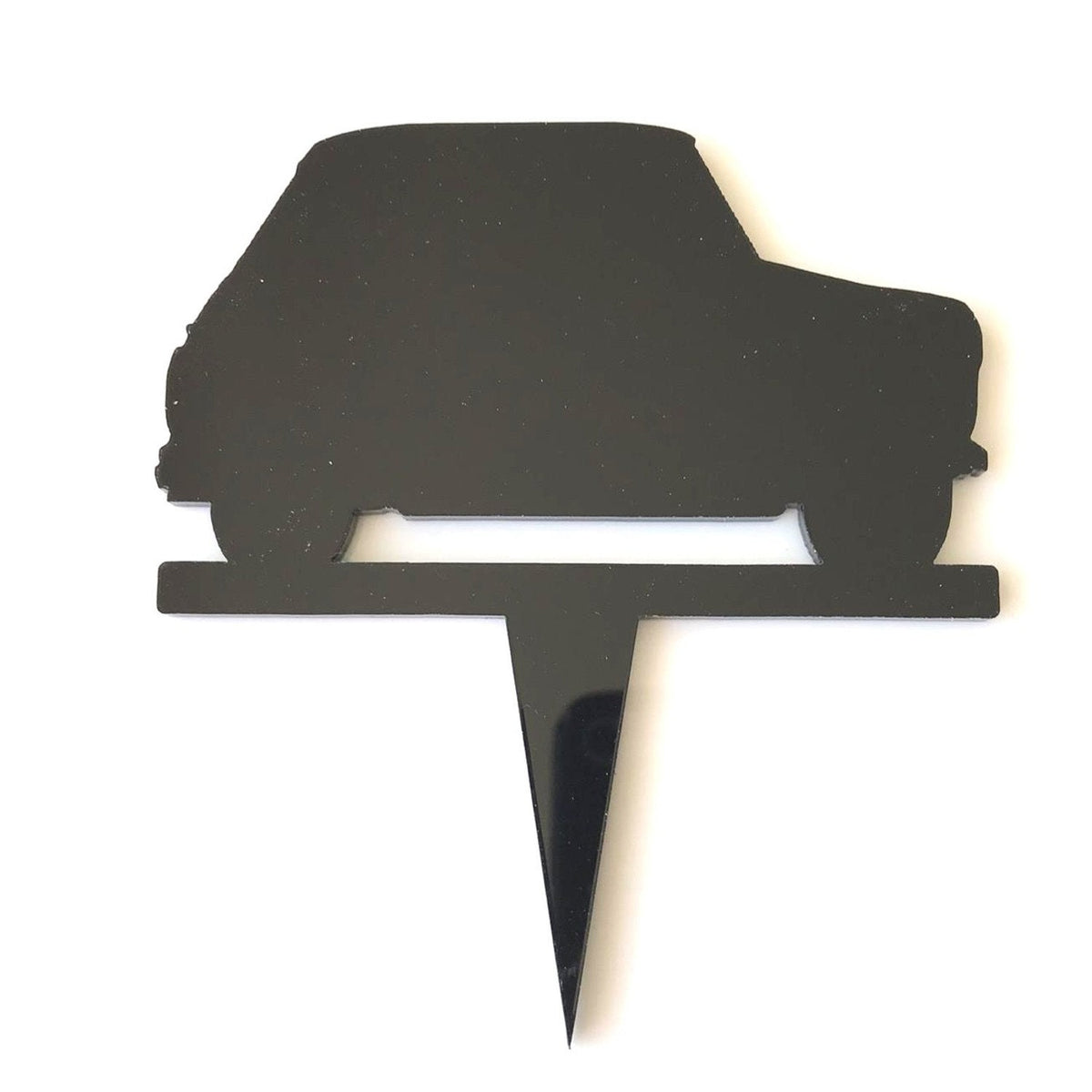 Black acrylic cake topper shaped as the silhouette of a hatchback car on a spike.