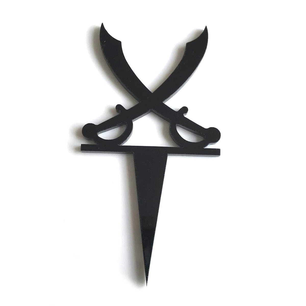 Black recycled acrylic cake topper featuring two crossed pirate swords on a spike base against a white background.