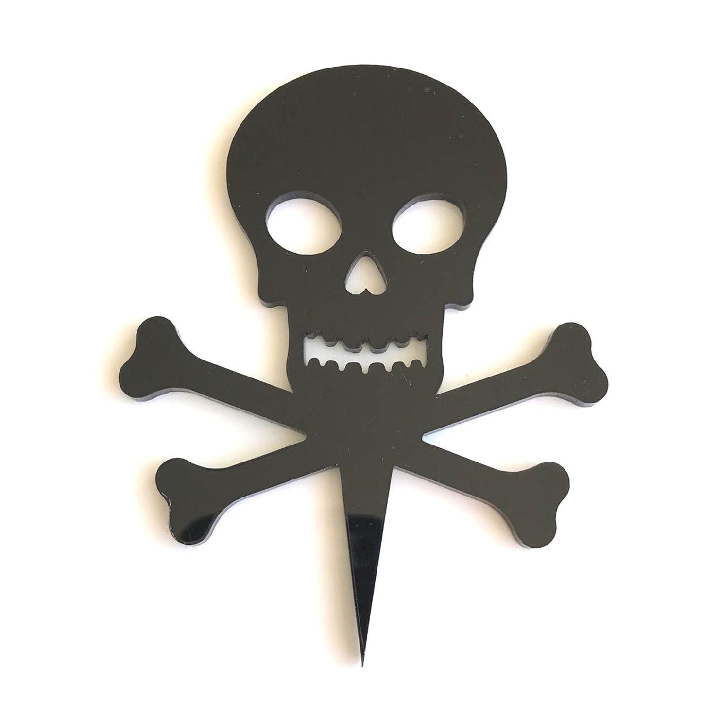 Black, glossy recycled acrylic skull and crossbones cake topper with a pointed stake at the base.