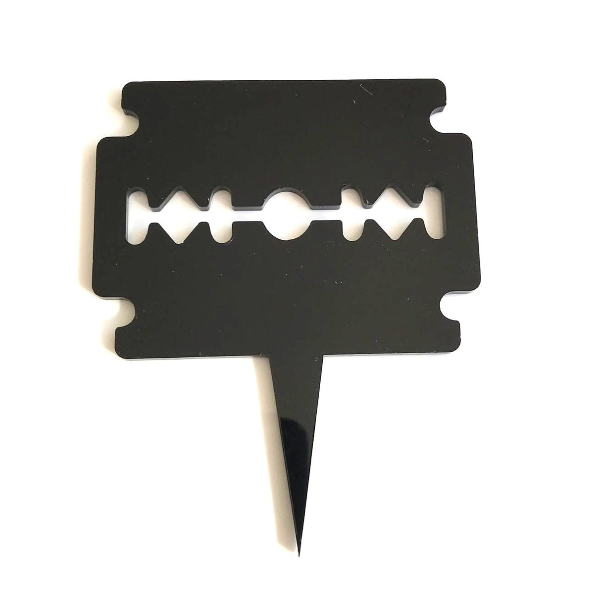 Black acrylic cake topper shaped like a traditional double-edged razor blade with a single pointed spike base.