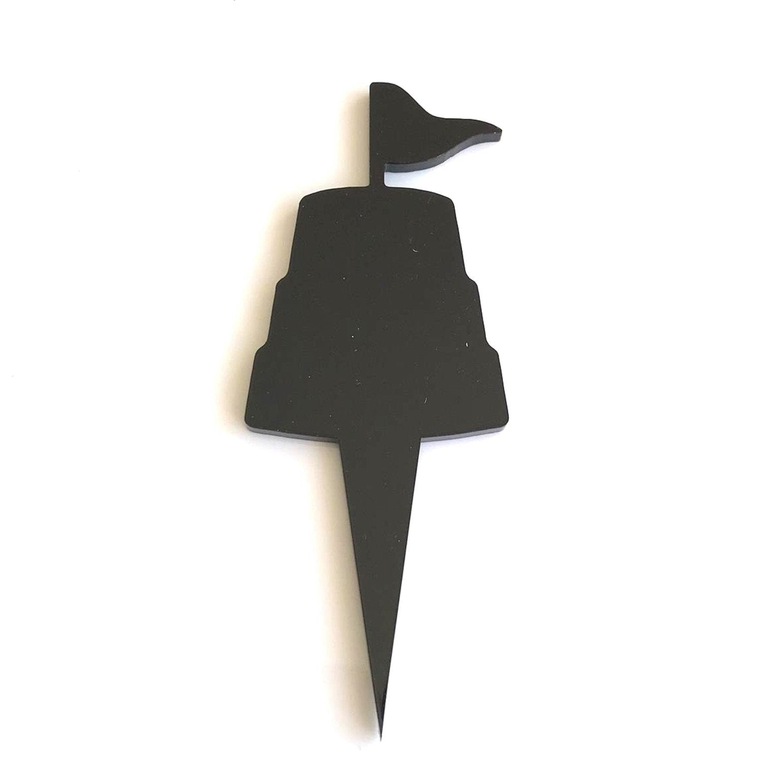 Black acrylic sandcastle-shaped cake topper with a flag silhouette and a pointed stake base.