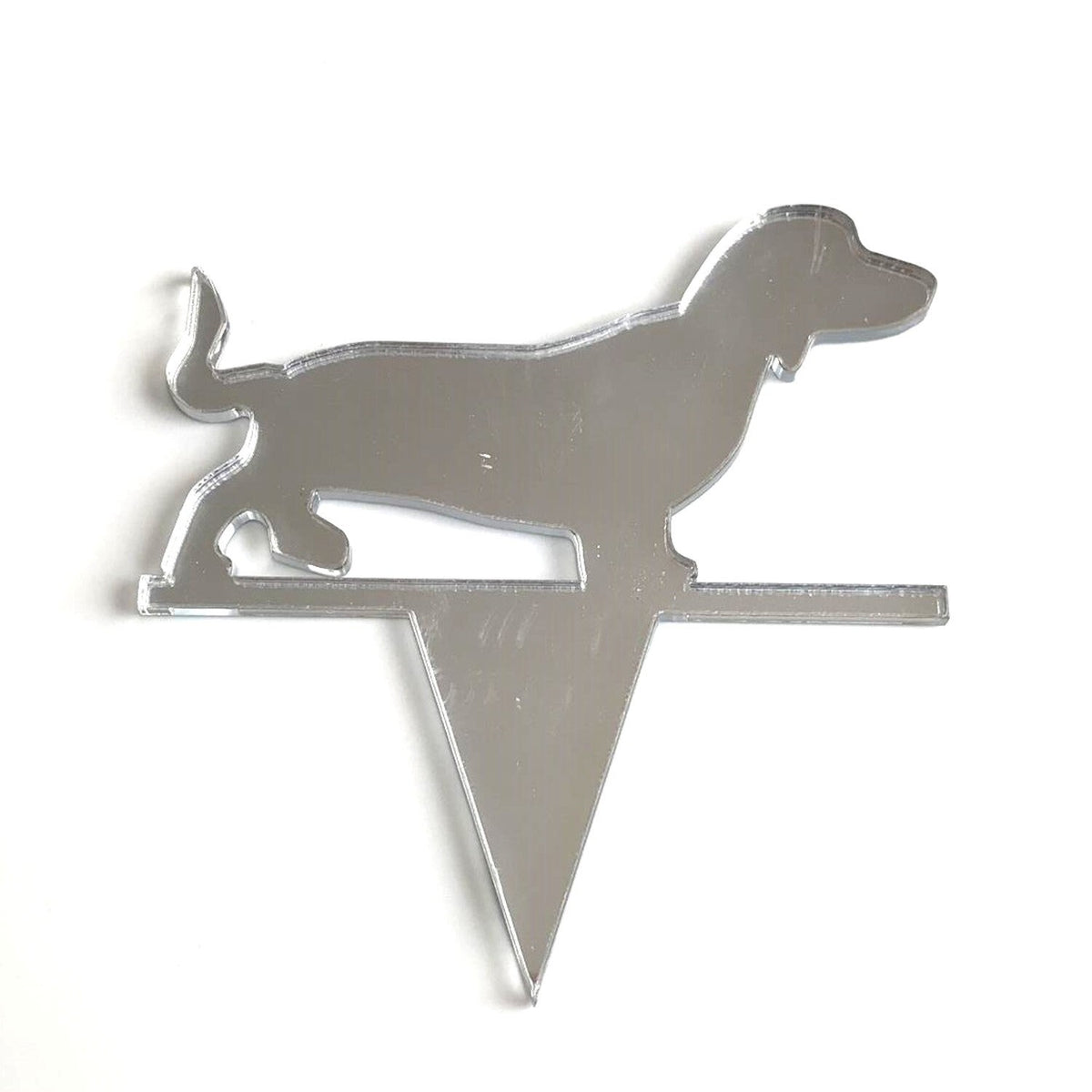 Silver mirror-finish acrylic cake topper in the silhouette shape of a dachshund dog.