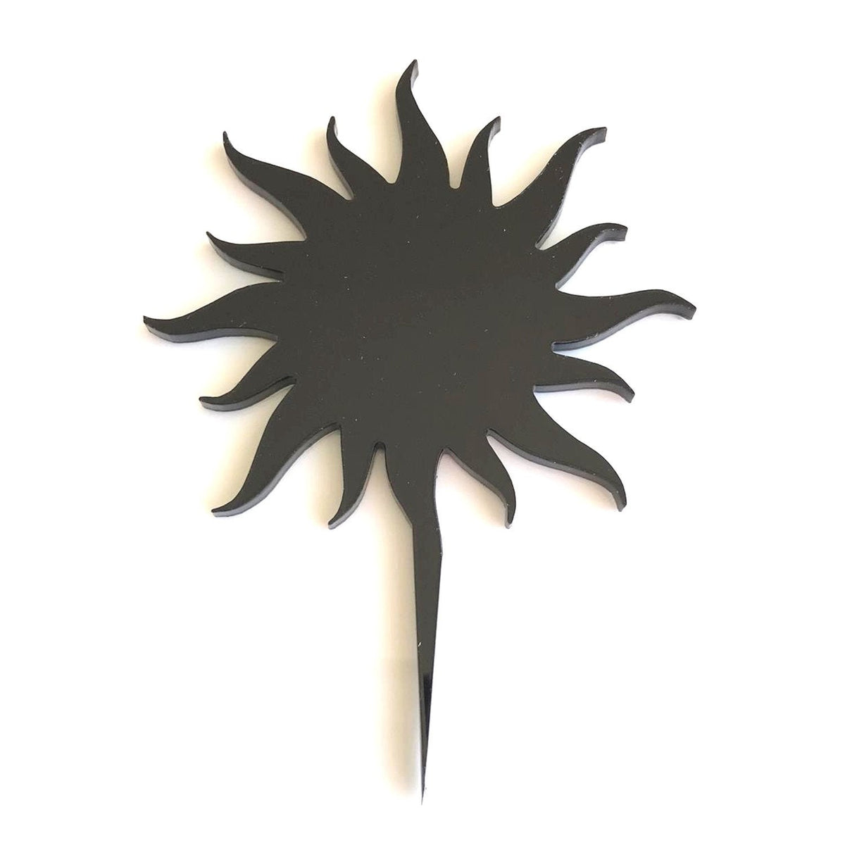 Black, eco-friendly, laser-cut sun cake topper with a sleek, pointed base against a white background.