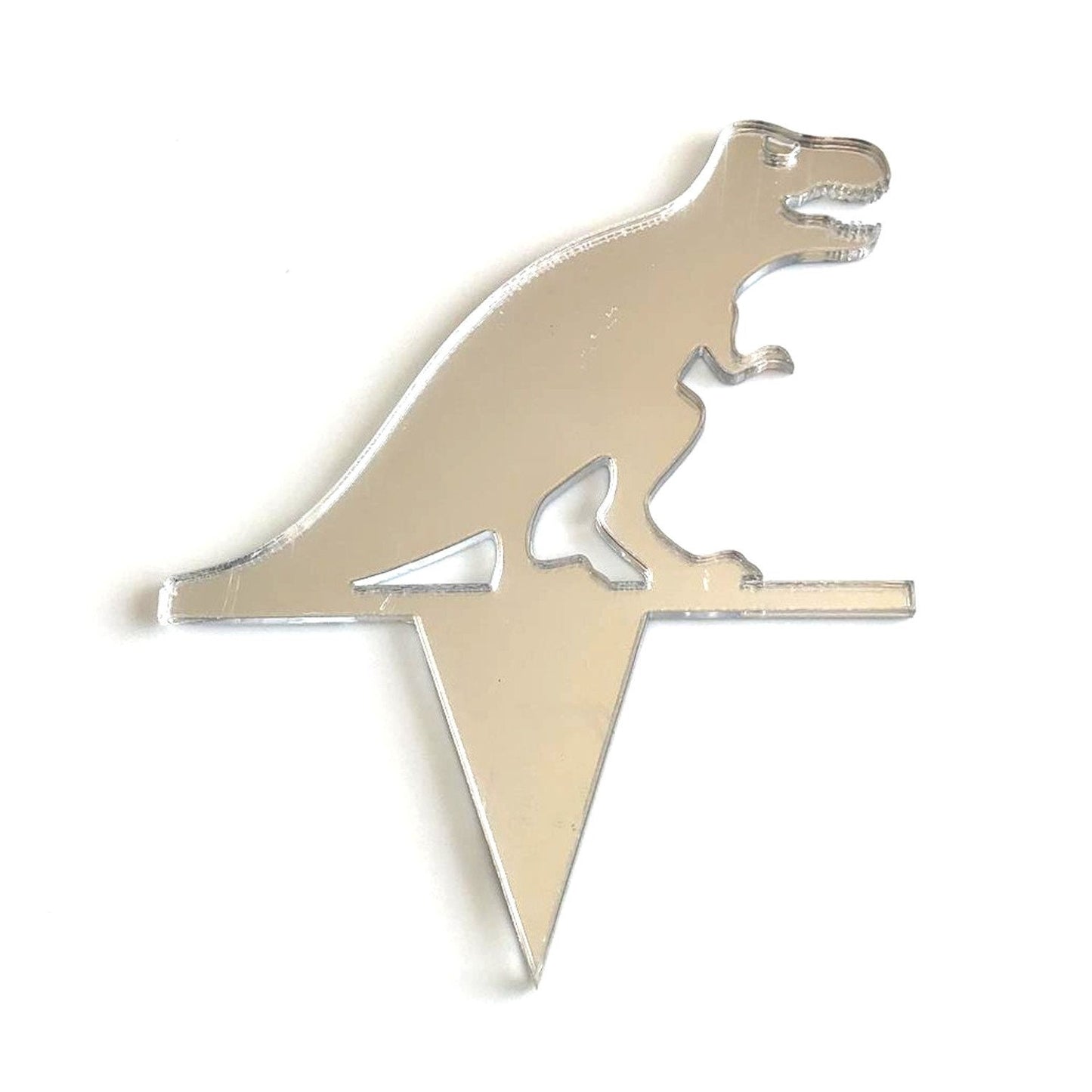 Mirror-finish silver acrylic T-Rex dinosaur cake topper with a triangular spike base.