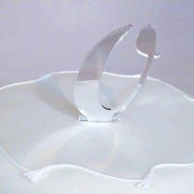 Silver mirror-finish acrylic laser-cut birthday cake topper shaped like the letter "C" standing on a white cake.