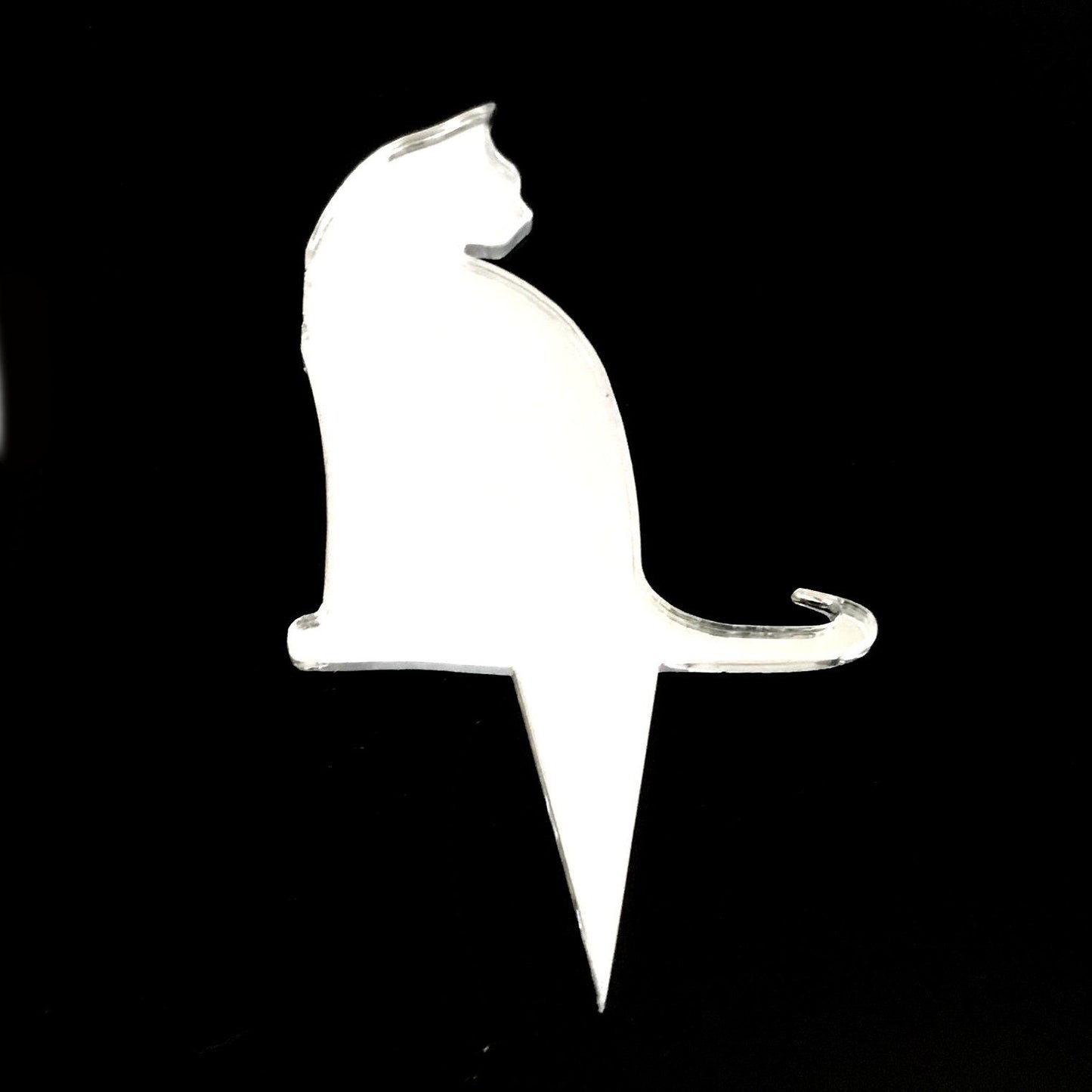 Clear acrylic cat-shaped cake topper silhouette by SuperCoolCreations against a black background.