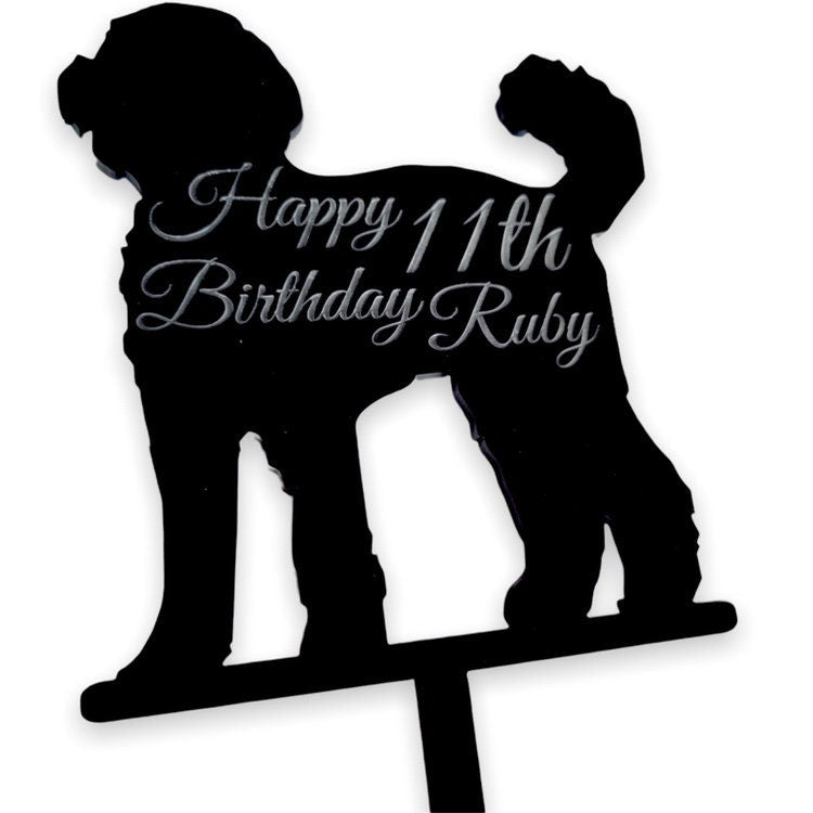Black acrylic Cockapoo cake topper engraved with "Happy 11th Birthday Ruby" in elegant script.