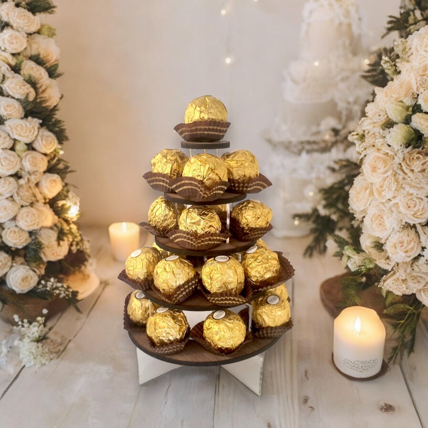 Tiered display stand with round wooden shelves on clear acrylic supports, filled with gold-foil wrapped chocolates.