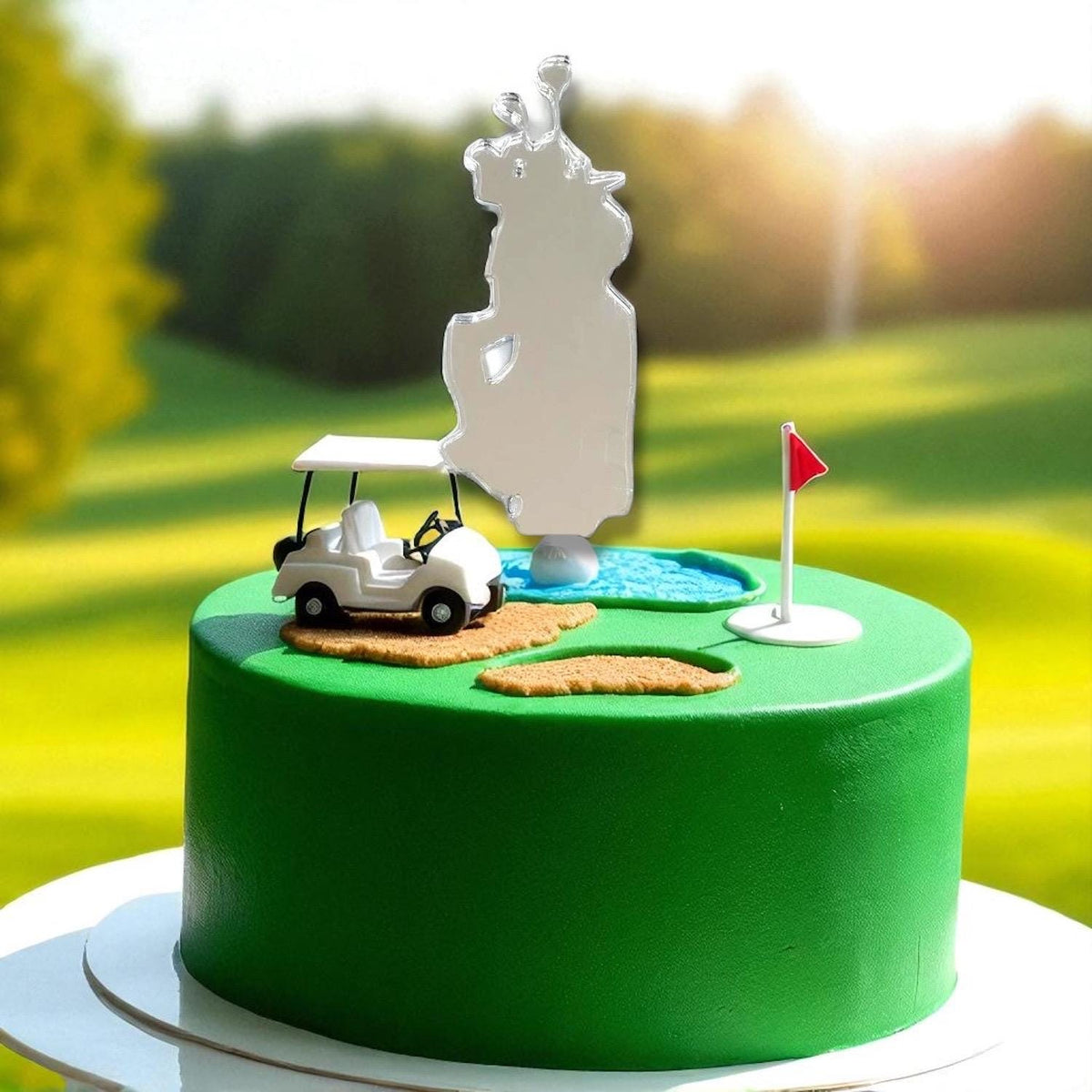 Clear acrylic golf bag cake topper on a green golf course cake with a toy cart and flag.