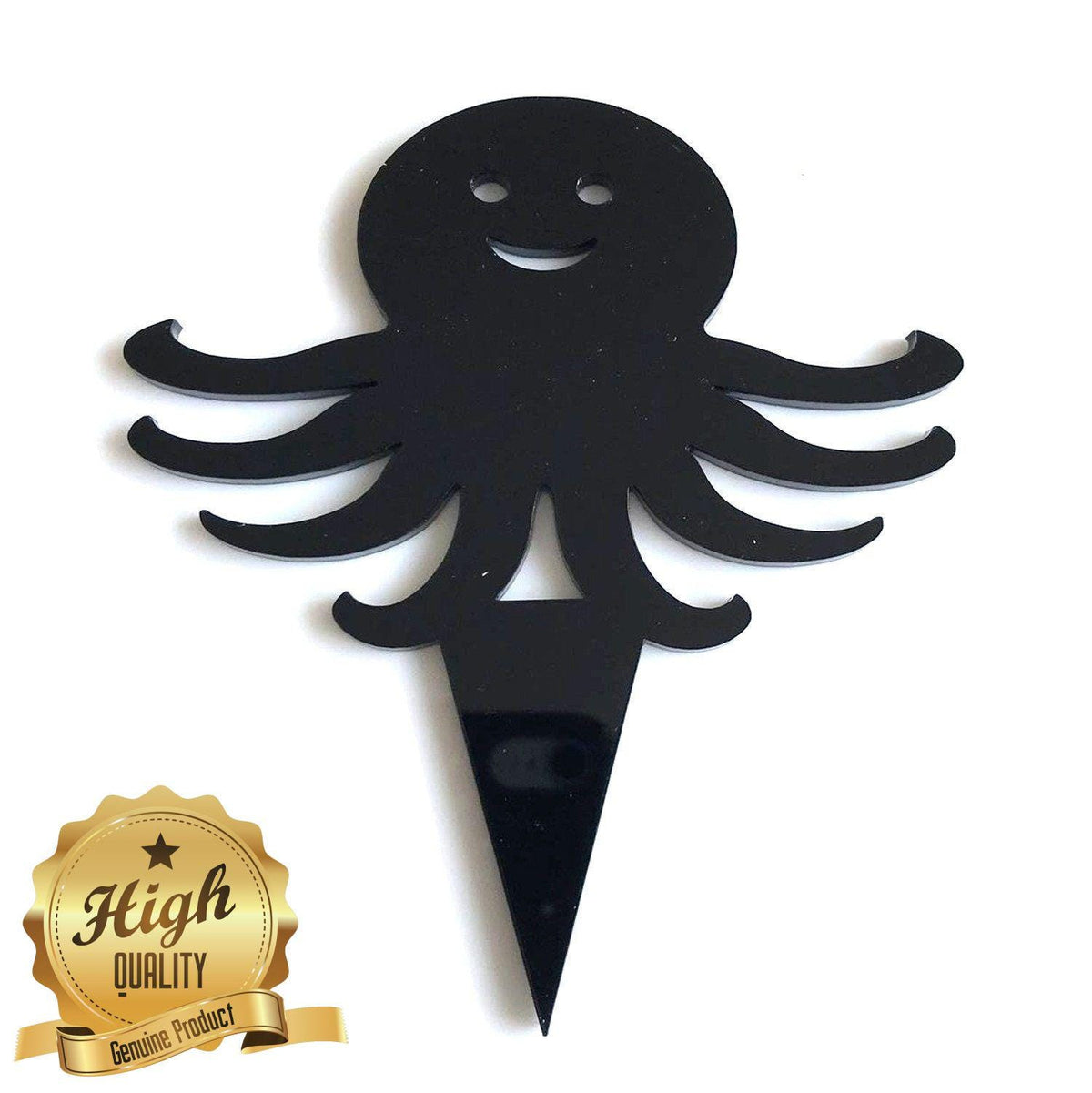 A shiny black, recycled material octopus cake topper with a smiling face and a pointed spike base.