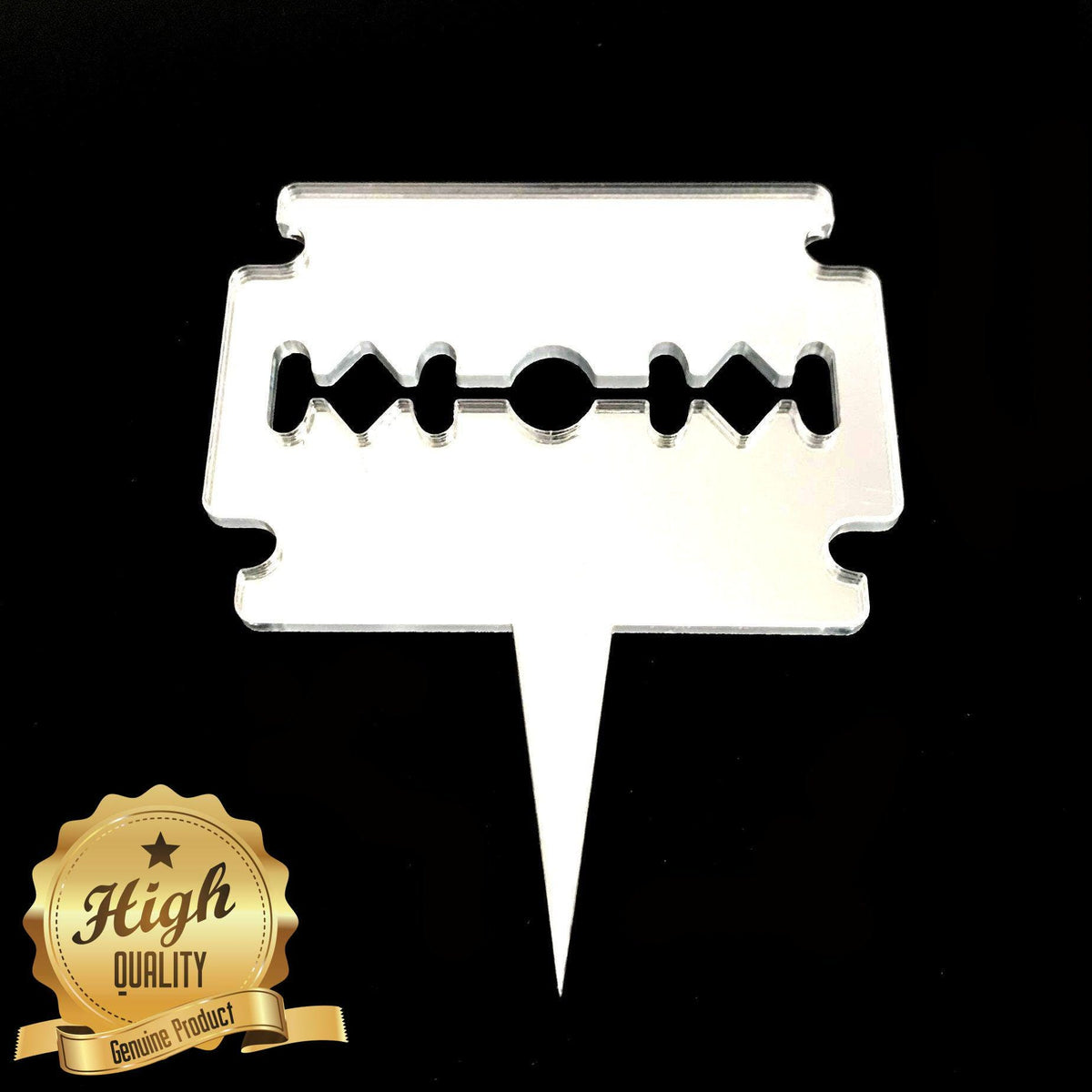 Clear acrylic razor blade cake topper with a cutout design that spells "MOM," isolated on a black background.