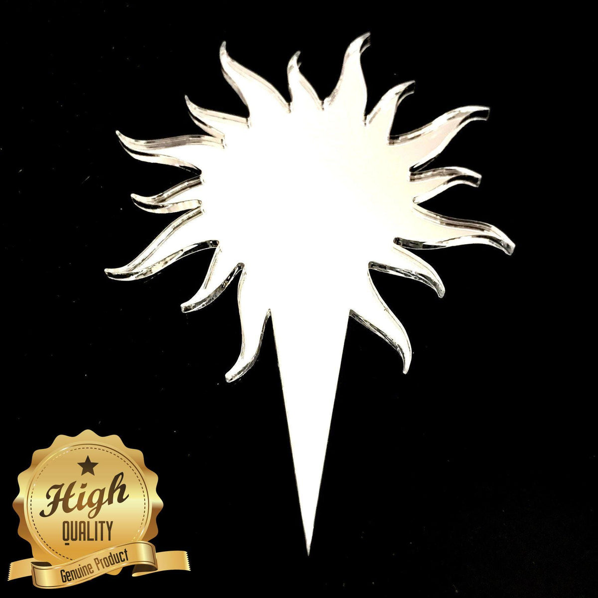 Laser-cut white sun-shaped cake topper with a sharp pointed base, set against a black background.