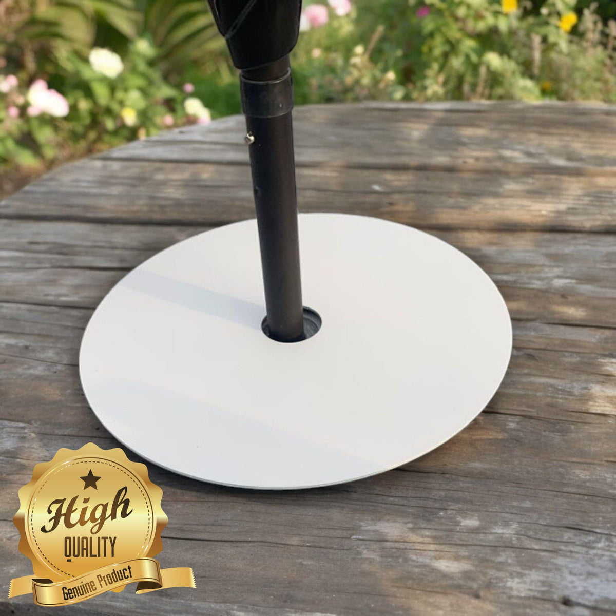 Large, round white acrylic lazy susan with a center parasol hole, placed on a wooden garden table.